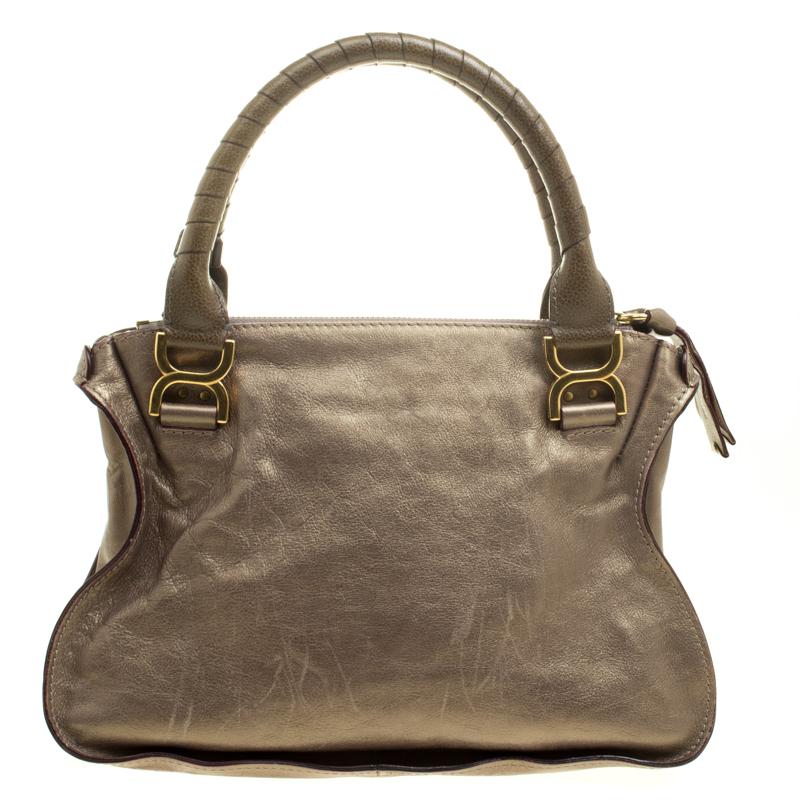 Stunning to look at and durable enough to accompany you wherever you go, this Chloe satchel is a joy to own! This Marcie bag is crafted from leather and features dual rolled handles. The insides are fabric lined and perfectly sized to carry your