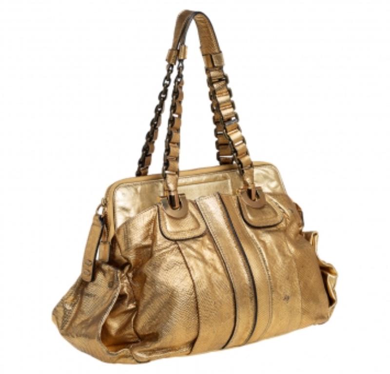 Coveted by fashionable women around the world, the Heloise is a bag worth the investment. It is from the Chloé. Stylish and practical, the bag is crafted from metallic gold leather and designed with braided handles, gold-tone hardware, and a