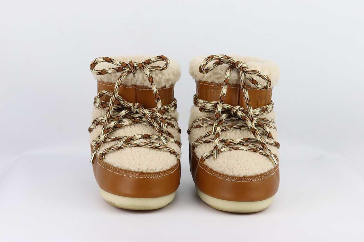 Chloé + Moon Boot shearling and leather snow boots. Shearling and leather snow boots with rope lace up detail around the front and shearling lined. Tan and cream Rounded toes. Ankle length. Platform heel. Pull on. Comes with box and dustbag. Size: