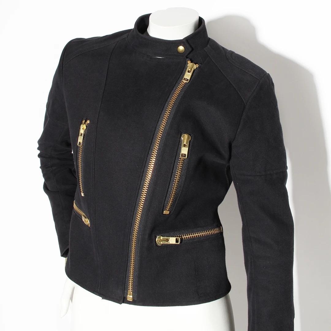 Chloé Motorcycle Jacket 
Made in France 
Vintage 
Black Cotton 
Reinforced cotton gives jacket a structured fit 
Four pockets with zip closures
Oversize gold zippers 
Mandarin style collar 
Snap closure at neck
Zipper detail at cuff of sleeves