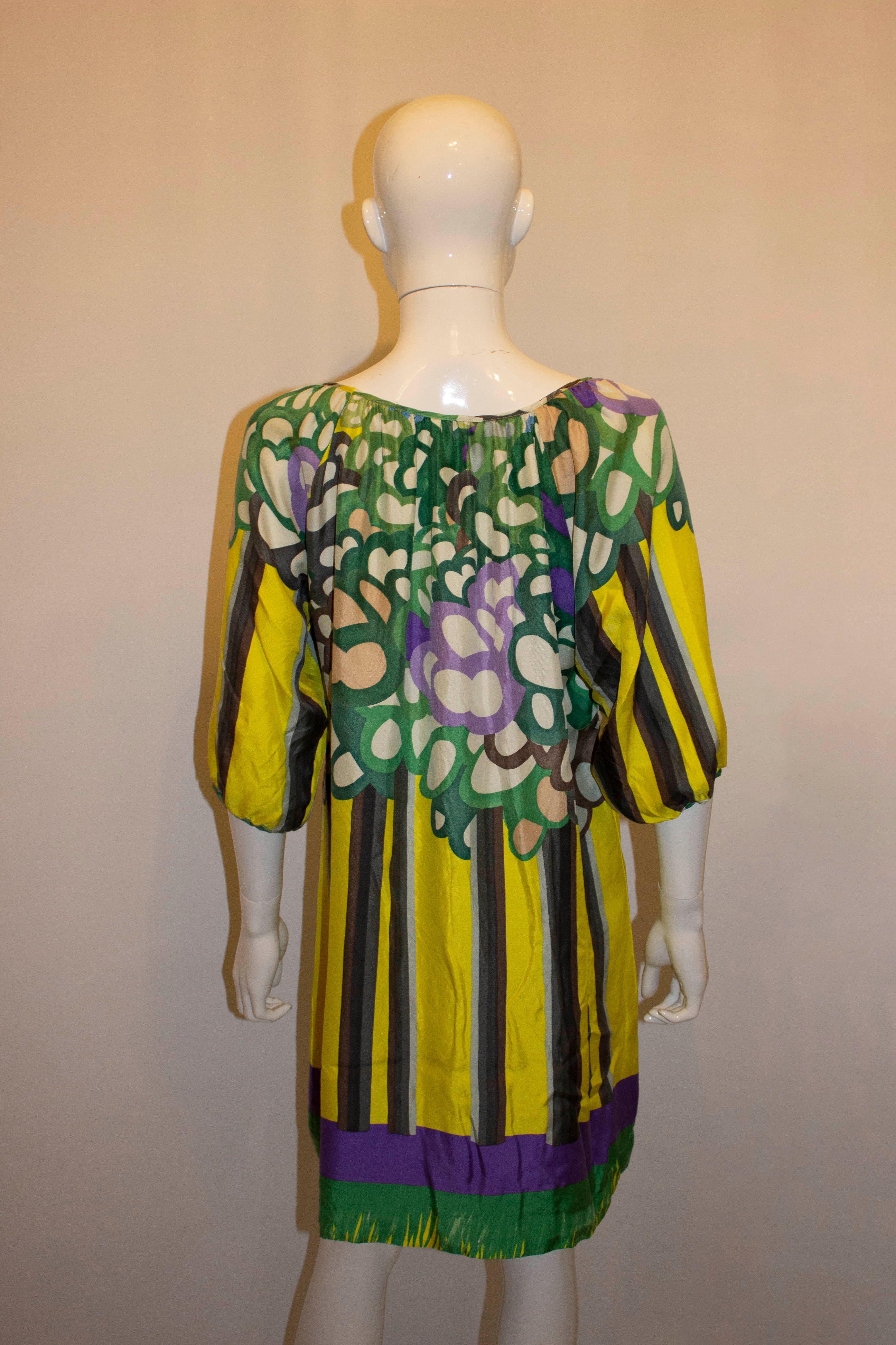A great silk dress /tunic for Sping /Summer by Chloe. In a wonderful colour combination of purple , green and white , the dress has elbow length sleaves. Measurements: Bust up to 42'', length 34''