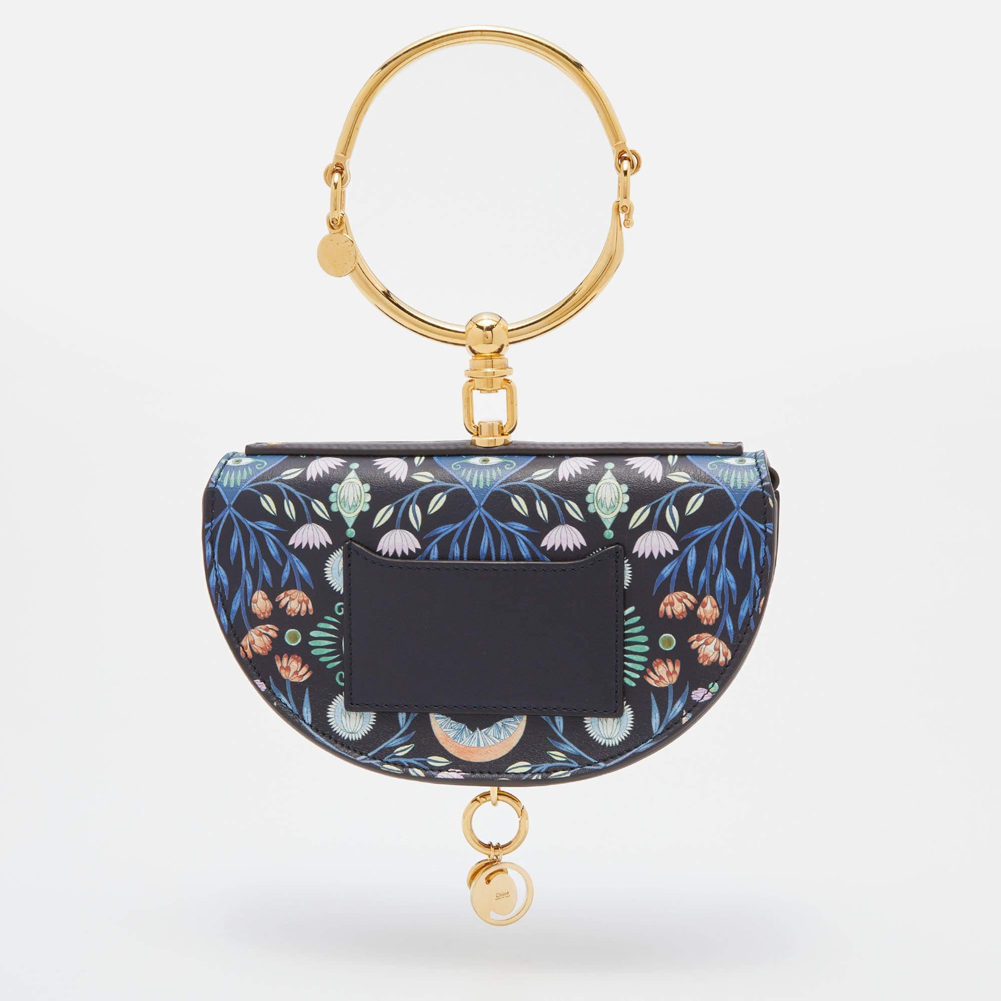 This one-of-a-kind Chloe Nile bracelet bag is from a special collaboration with Indian artist Rithika Merchant. The Nile's iconic half-moon silhouette is lit with wondrous motifs from the artist's universe. A truly special piece.

Includes: