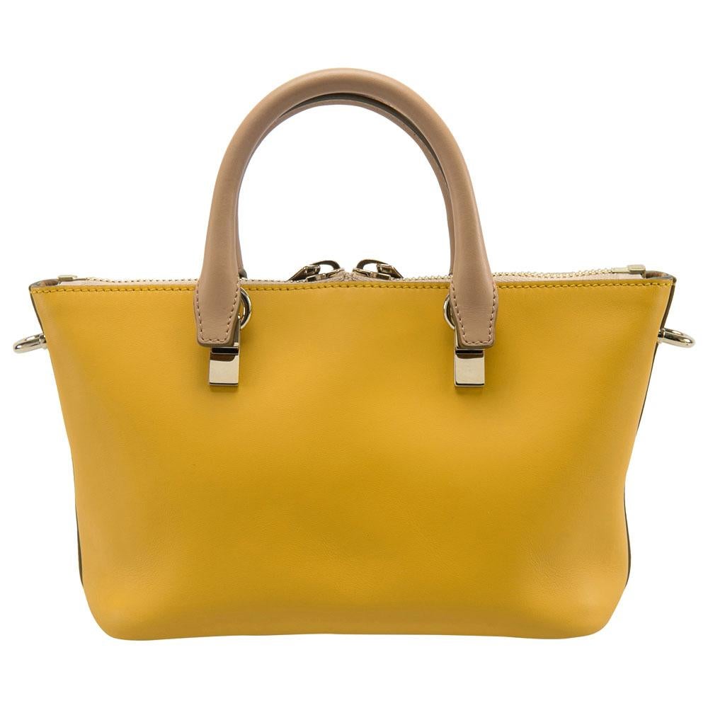 One of the many Chloe popular bags, the Baylee bag made its first appearance at 2013 Fall runway. It has a minimal design but with very interesting details. The smooth mustard-beige leather exterior is paired with rolled handles, a gold-tone chain