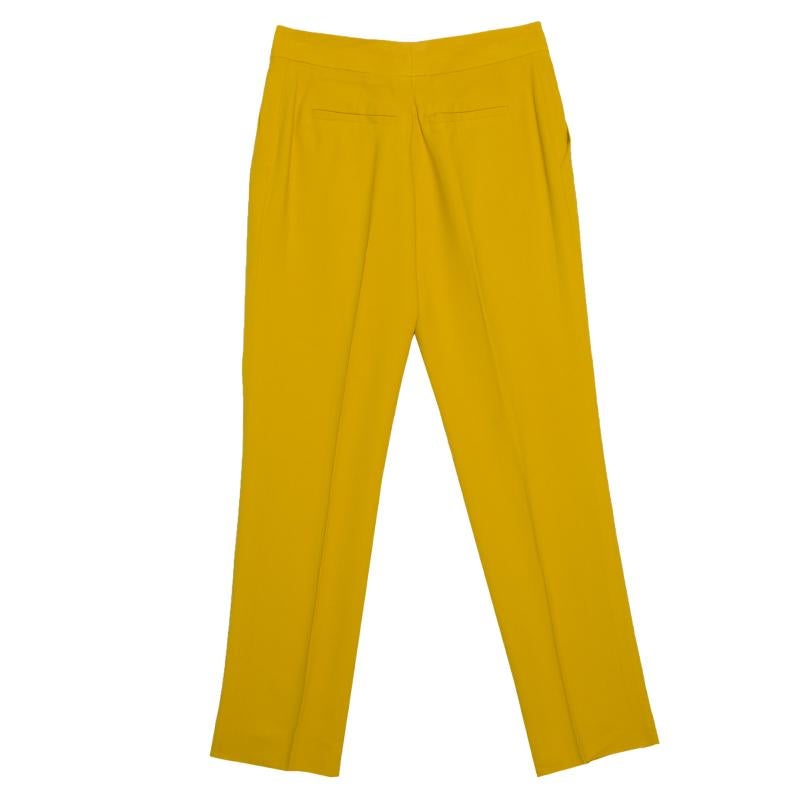 Vibrant and oh so lovely, these gorgeous mustard yellow trousers from Chloe will surely gladden your heart! They are made of a viscose blend and feature a high waisted silhouette. They come equipped with front and back pockets and can be paired well