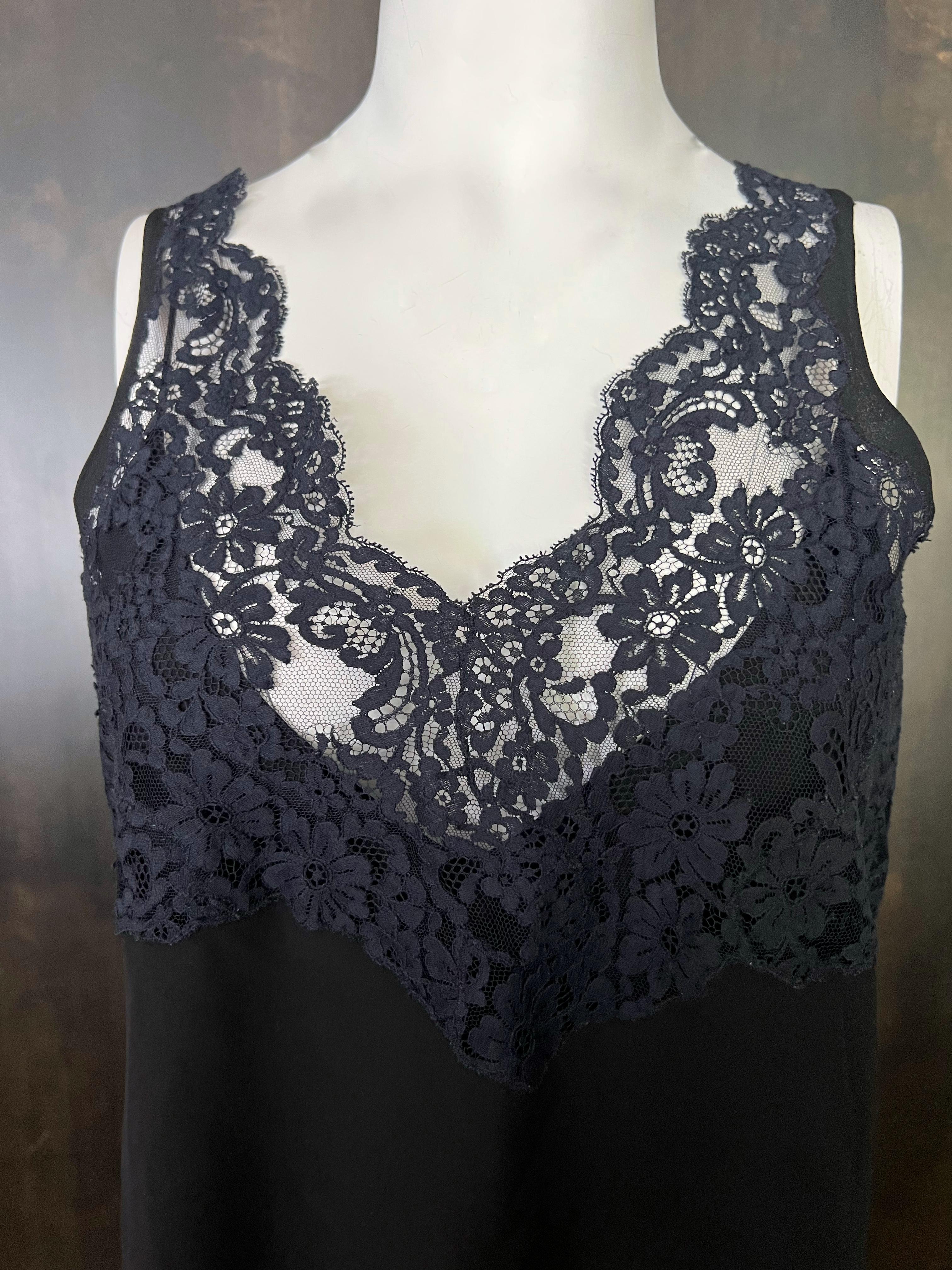 - Sleeveless
- Featuring black slick with navy lace detail
- Includes black cami top with spaghetti straps 
- V neckline


