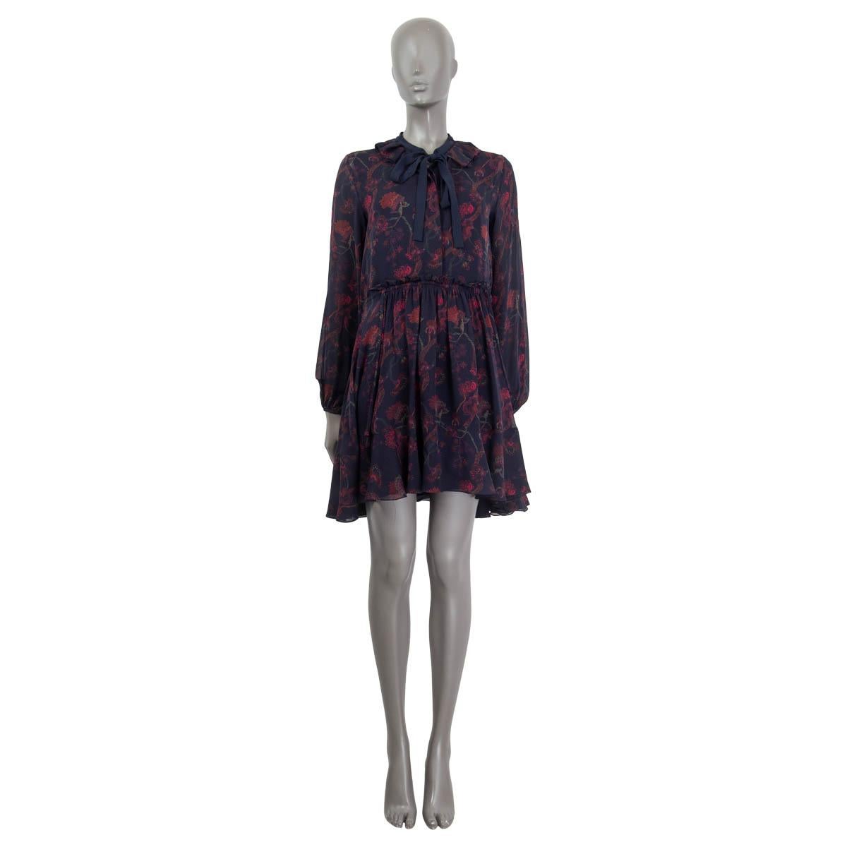 100% authentic Chloé long sleeve floral dress in navy, red, burgundy and green silk georgette (100%). Features a self-tie bow, buttoned cuffs and drawstring closure at the waist. Opens with  four concealed buttons on the front. Lined in navy silk
