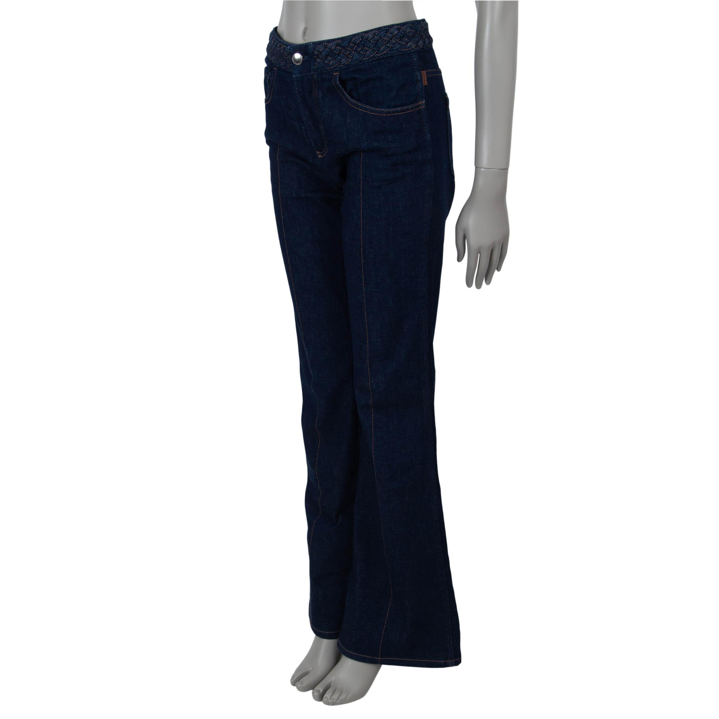 These 100% authentic Chloé jeans in navy blue cotton (83%), polyester (16%), and elastane (1%) offer a chic retro-inspired silhouette. Featuring a high waist and slim legs that flare from the knee, they are accented with a braided waistband and