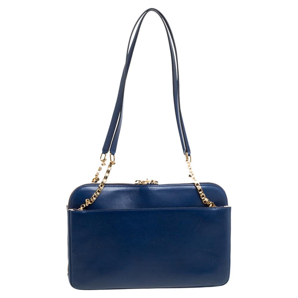 Shoulder bags as pretty as this one by Chloe are not creations you find every day. That's why this bag is worthy of a place in your closet. It has been crafted from blue leather and styled with gold-tone zippers and chain-link details. The zippers