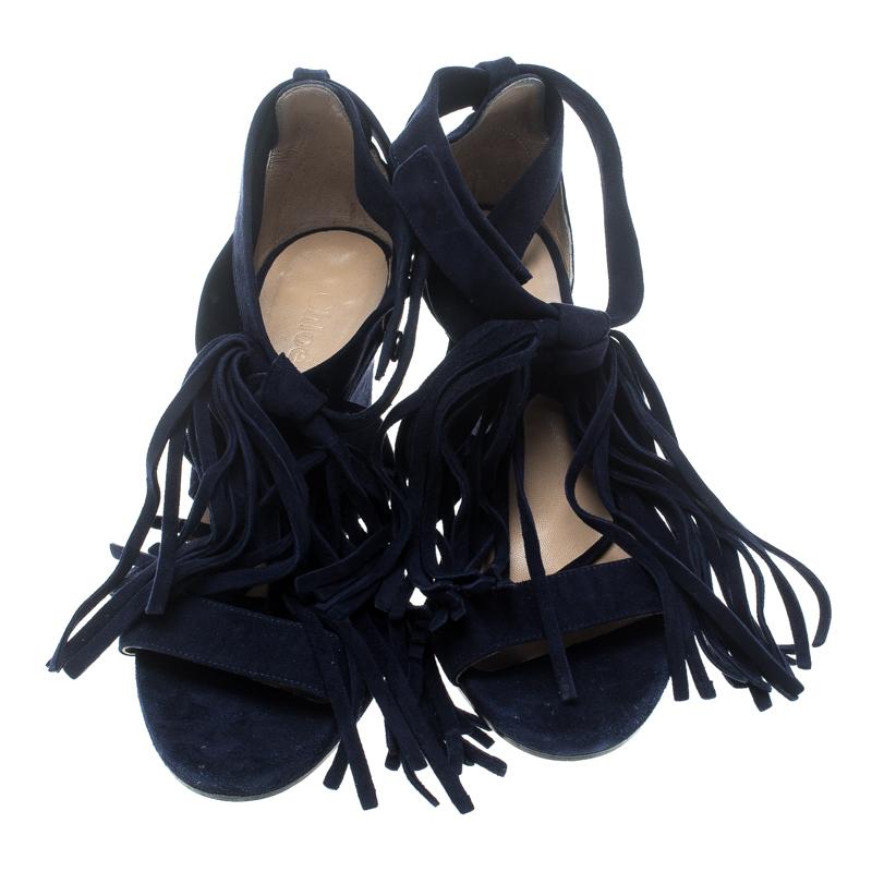 Chloe never fails to impress and yet again charms us with these lovely navy blue sandals. They are crafted from suede and feature an open toe silhouette. They flaunt single vamp straps and cross ankle straps with fringed tassels that give them a