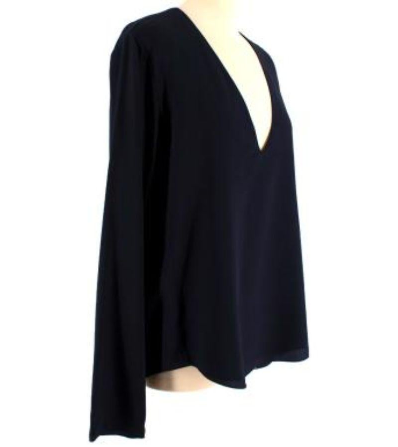 Chloe Navy V-neck Silk Top

- Long sleeved
- V neckline
- Fully lined
- Light construction

Material
100% Silk

Made in Madagascar

9.5/10 Excellent condition

PLEASE NOTE, THESE ITEMS ARE PRE-OWNED AND MAY SHOW SIGNS OF BEING STORED EVEN WHEN
