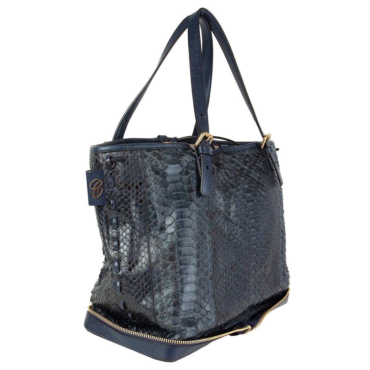 Chloé 'Ellen Moyen' tote bag in deep petrol python with navy leather bottom, handles and trimming featuring decorative zipper detail around the bottom part. Lined in beige canvas with one zipper pocket against the back and one open pocket against