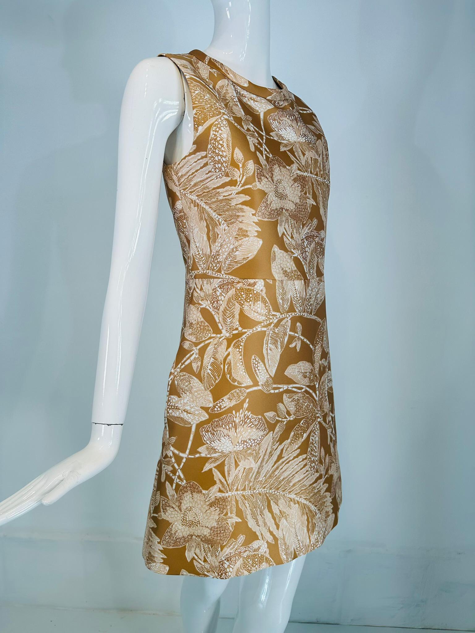 Chloe ochre & white floral sleeveless mini dress. Beautiful soft ochre colour floral dress perfect for any special occasion. Round band collar neckline, A line shape dress has a seamed waist & on side hip pockets. The dress back features vertical