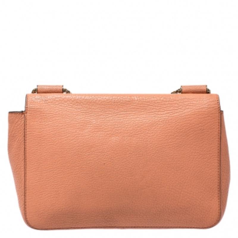 Every curve and detail on this Chloe Elsie is grand which adds to the worth of the bag. It has been crafted from leather and styled with a flap. The bag is secured by a turn-lock revealing a well-sized interior and completed with a chain shoulder