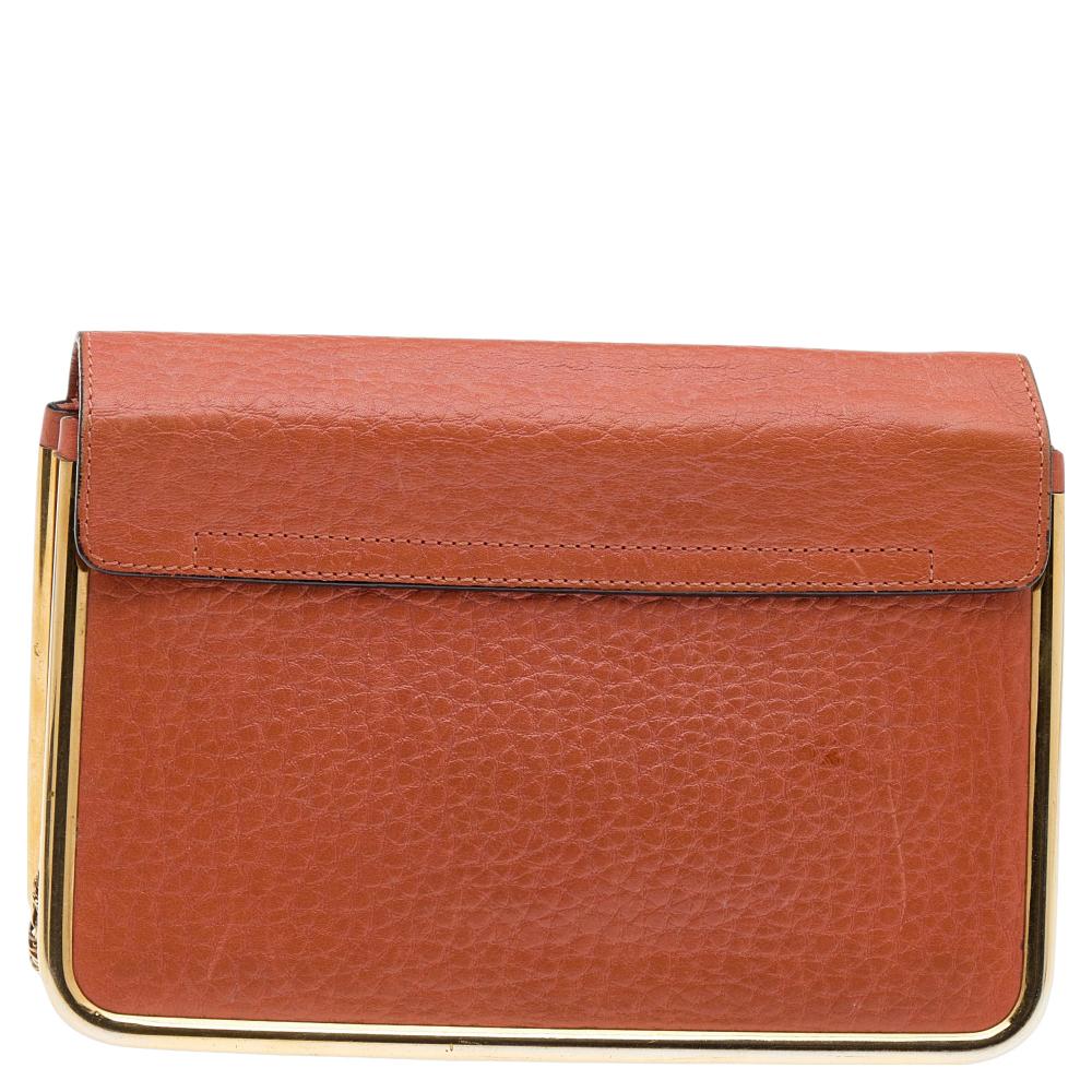 This stylish Sally shoulder bag from Chloe is crafted from orange leather and gold-tone metal. The bag features a chain handle and a flip-lock on the flap. This Sally is added with a spacious lined interior.