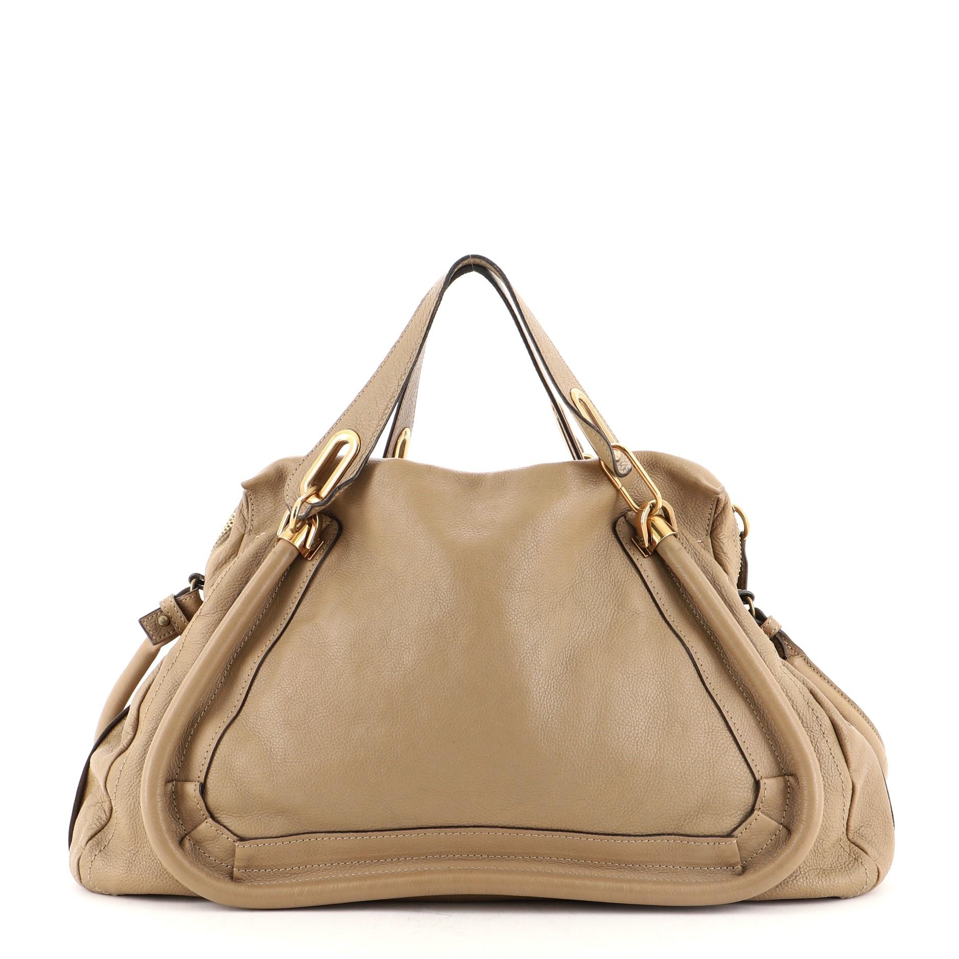 Chloe Paraty Top Handle Bag Leather Large
Neutral

Condition Details: Creasing on exterior, minor wear on opening corners, handles and strap small indentations on exterior trims. Heavy splitting and cracking on handle, opening and strap wax edges,
