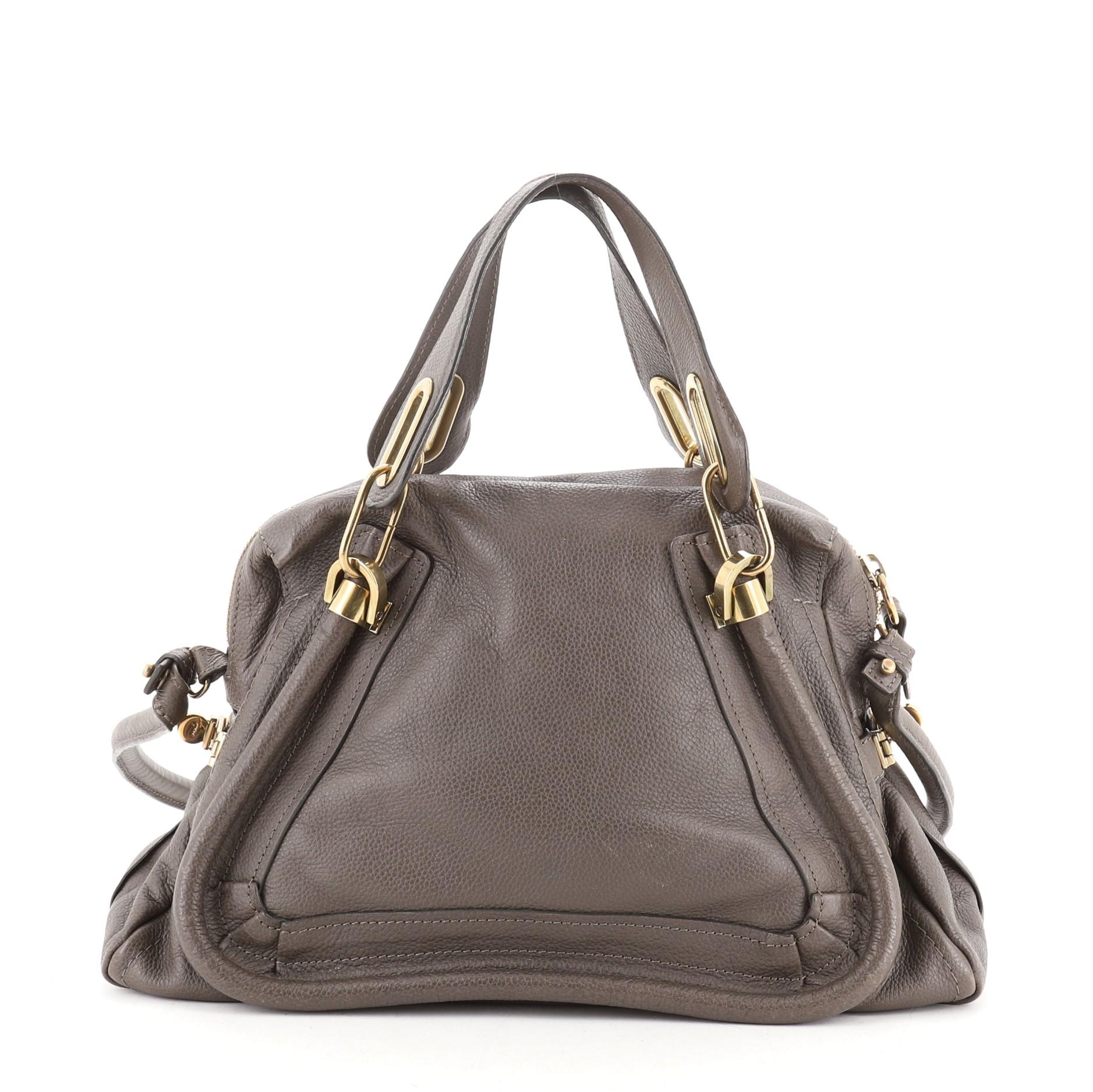 Chloe Paraty Top Handle Bag Leather Medium
Brown

Condition Details: Creasing and wear on exterior, cracking on handle and strap wax edges. Discoloration in interior, scratches on hardware.

50842MSC

Height 9