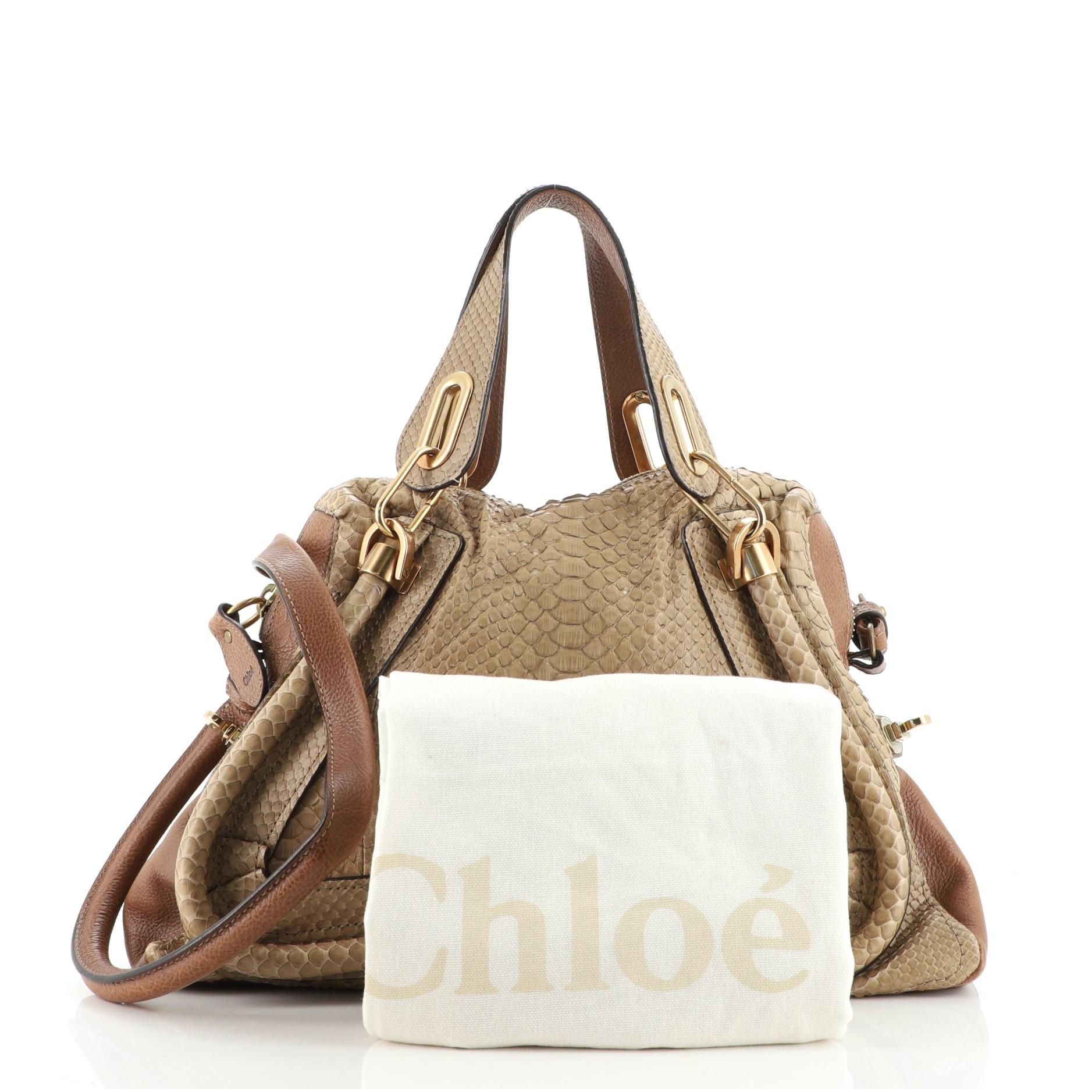 Condition: Very good. Odor in interior. Lifting of scales on exterior and handles, creasing on exterior, wear on exterior corners, handles and in interior, scratches on hardware.
Accessories: Dust Bag, With Strap
Measurements: Handle Drop 6