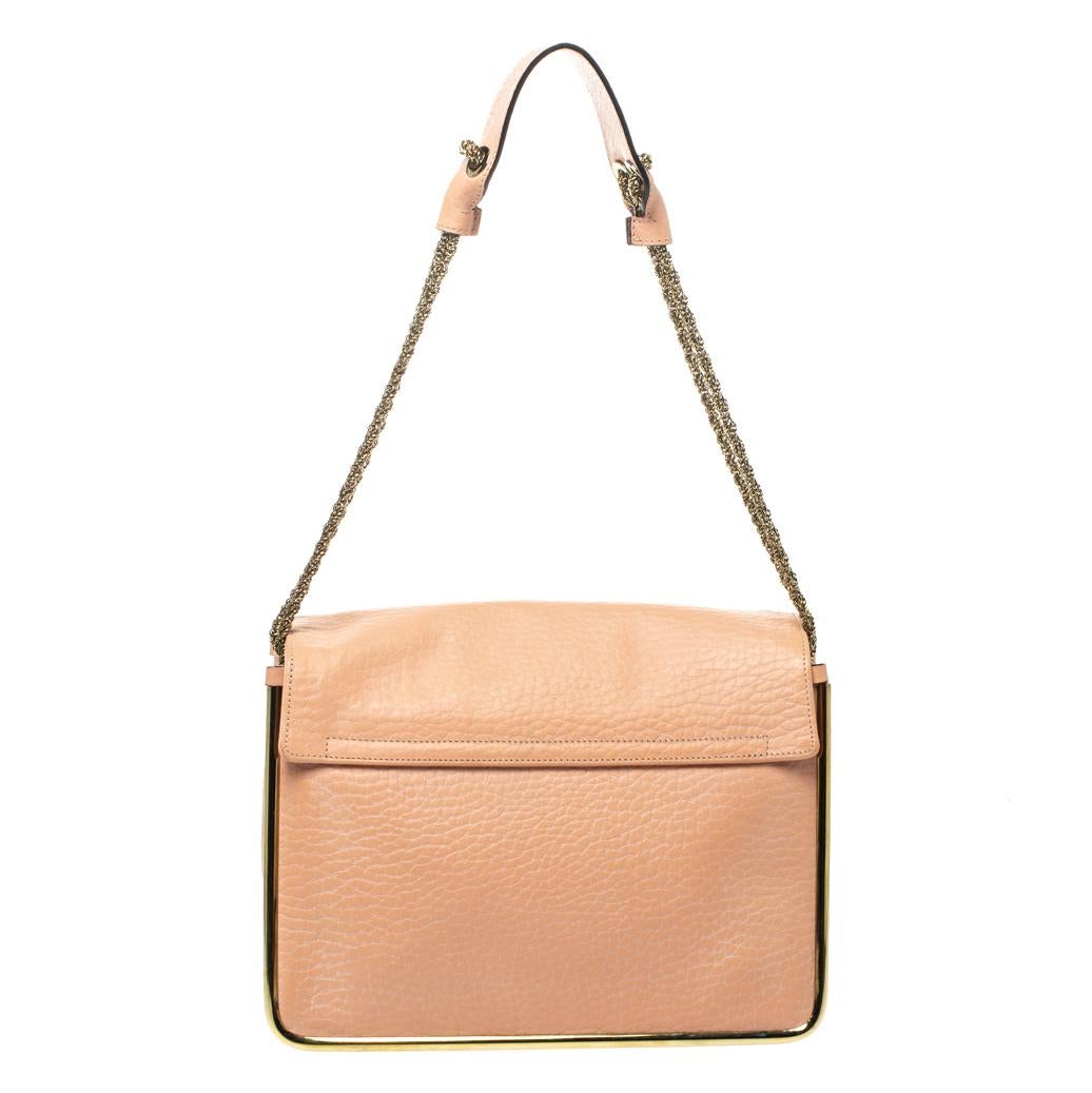 This stylish Sally shoulder bag from Chole is crafted from peach leather. The bag features a chain-link strap with leather shoulder rest and a stunning flip-lock in gold-tone. The flap opens to a spacious canvas-lined interior that houses a zip