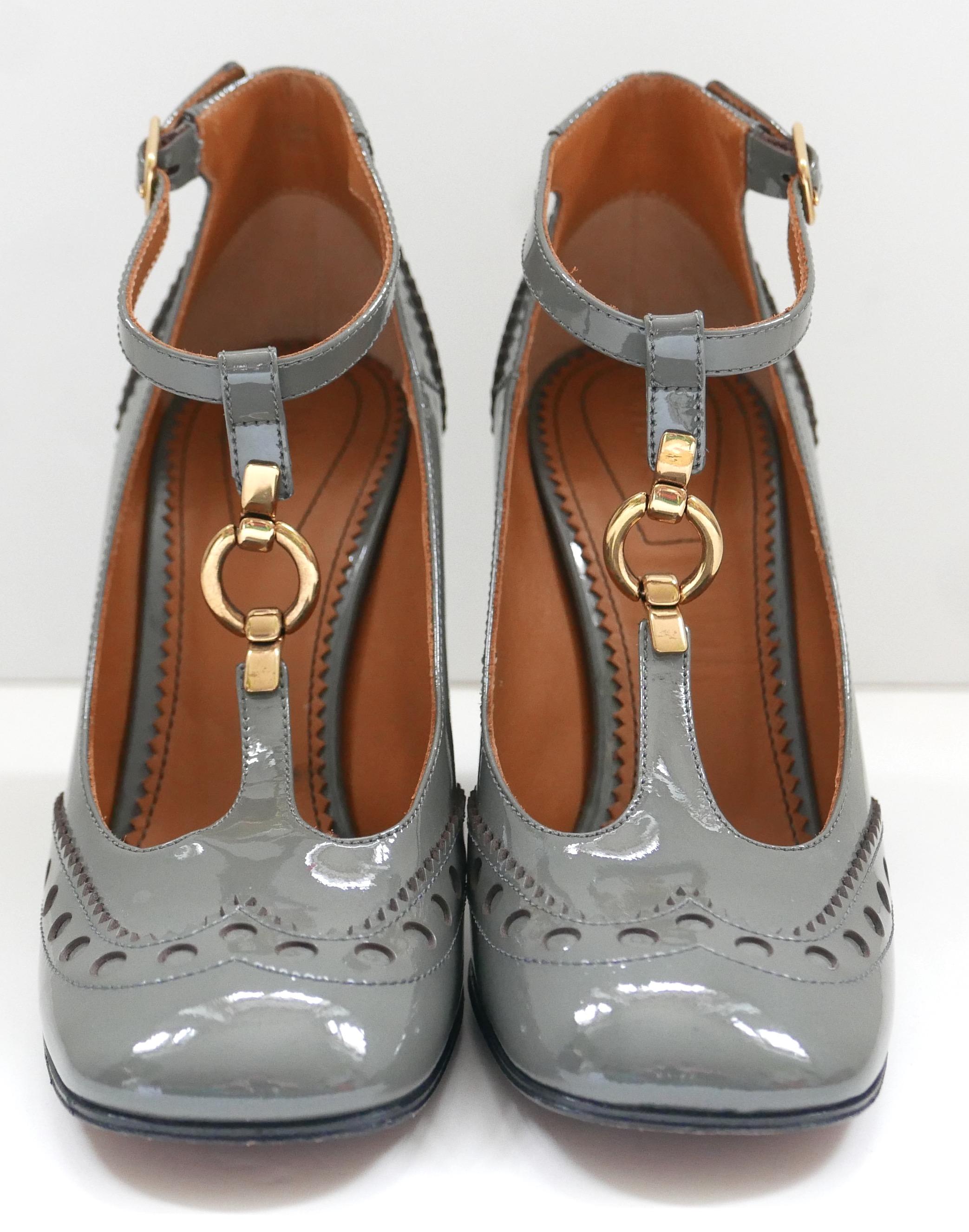 Gorgeous Chloe Perry t-bar pumps. Worn once and come with 1 x dustbag. Made from punched grey patent leather with brass ring trimmed t-bar front and half stacked block heels. Size 35.5. Measures approx - 9.75” heel to toe and heel is 3.5”
