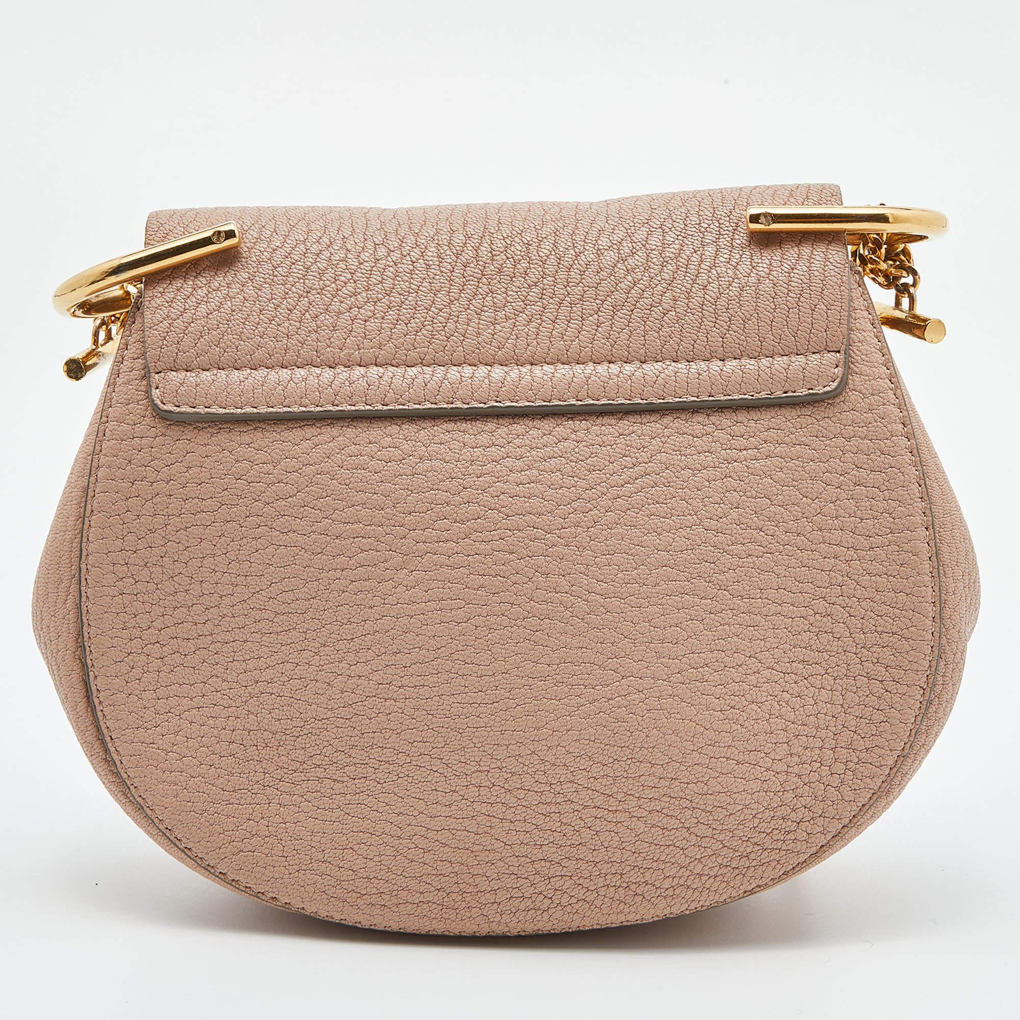 One of the most recognizable bags in the luxury world, Chloe's Drew bag is known for its distinct shape and minimal style detailing. This shoulder bag has been meticulously crafted from leather and designed with a pin lock closure and a shoulder