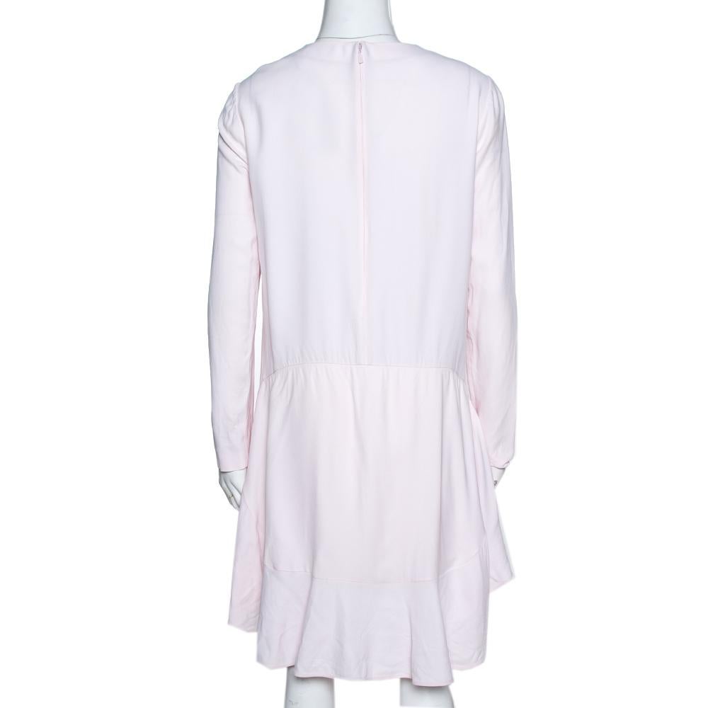 Perfect for fun days with friends and brunch dates, this flounce dress comes from the iconic house of Chloe. Designed to deliver effortless style, this luxurious creation comes in a feminine hue of pale mist. This dress is styled with long sleeves,