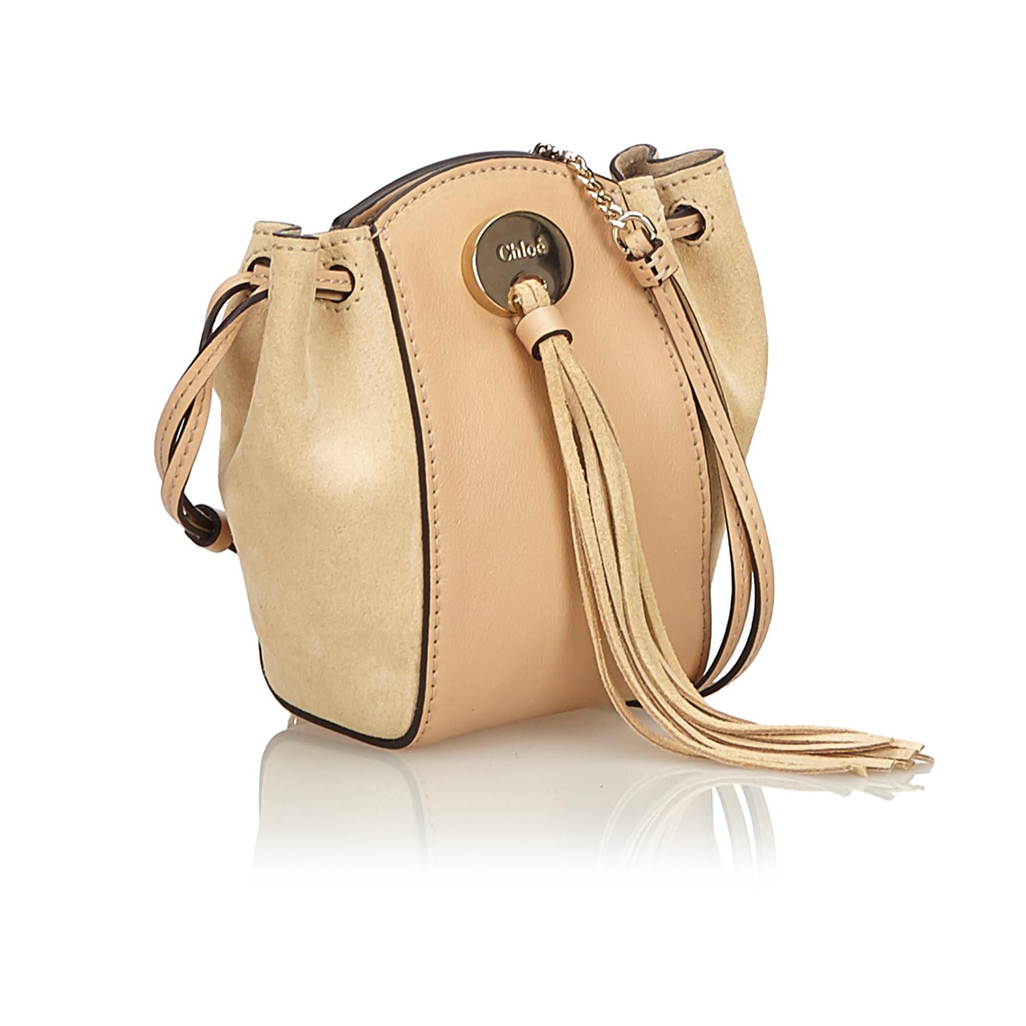 This shoulder bag features a leather and suede body, chain and tassel detail, flat leather strap, drawstring with button clasp closure. It carries as B+ condition rating.

Inclusions: 
Dust Bag
Box

Dimensions:
Length: 13.00 cm
Width: 14.00