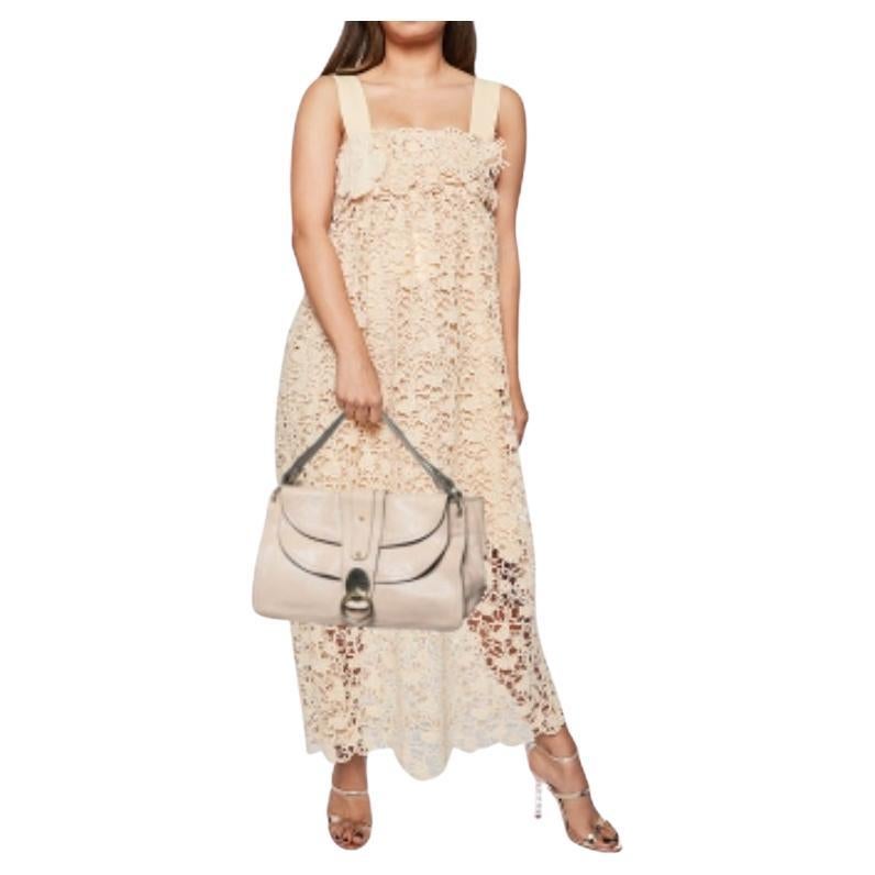 Stunning in appeal and simple in design, this satchel by Chloe will be a valuable addition to your closet. Crafted from textured leather, the bag features flat handles. The flap closure opens to a spacious fabric-lined interior to hold all your