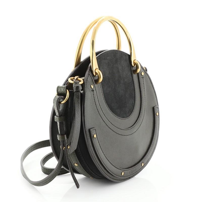 This Chloe Pixie Crossbody Bag Leather and Suede Small, crafted in green leather, features dual matte gold handles, round silhouette and matte gold-tone hardware. Its zip closure opens to a neutral suede interior with slip pocket. 

Estimated Retail