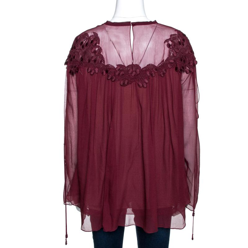This stylish and feminine top comes from the house of Chloe. Crafted from 100% silk, this top comes in a lovely shade of burgundy. It exudes sophistication and will instantly elevate your outfits. It s styled with a simple round neck, gathered style