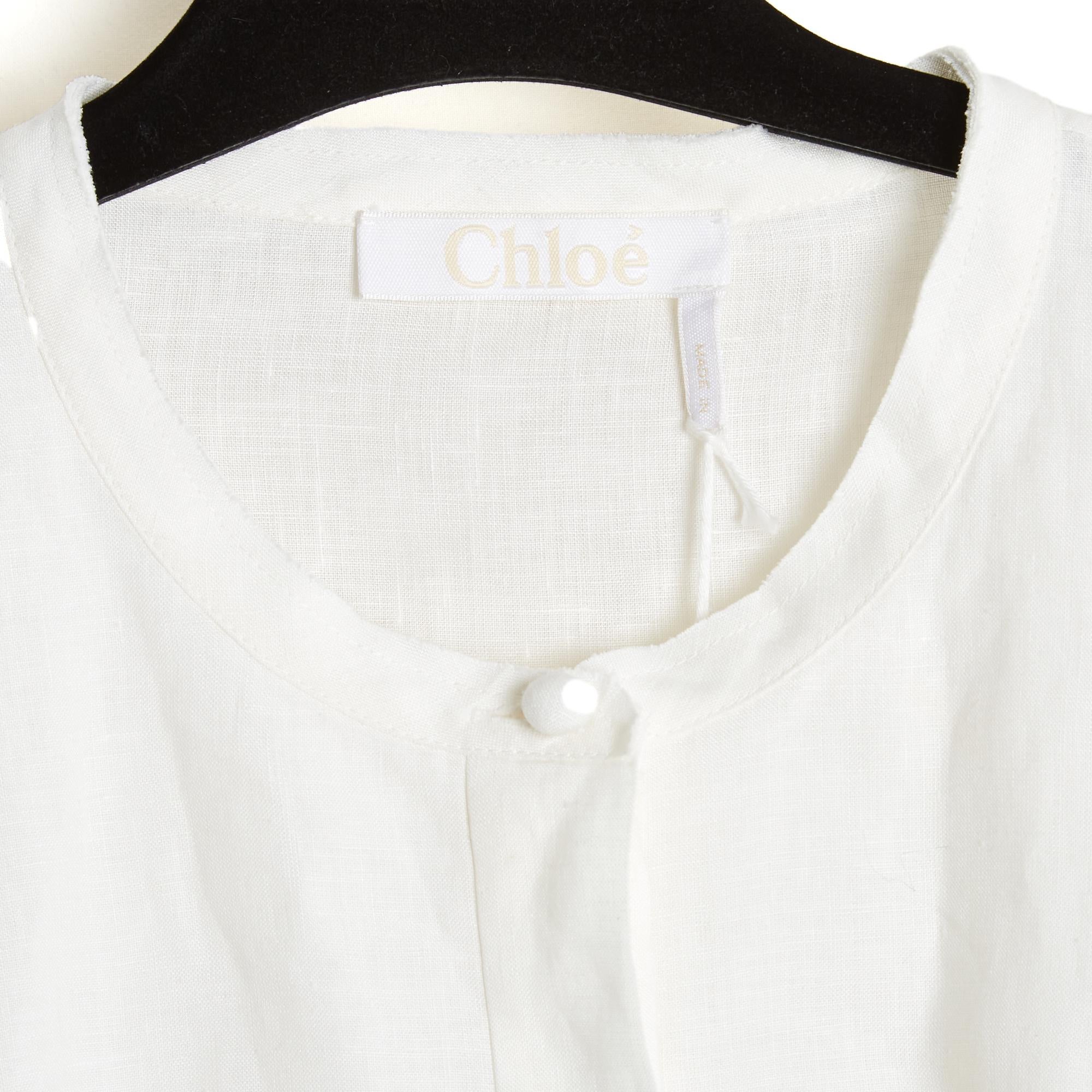 Chloé blouse from the Pre Fall 2022 collection by Gabriela Hearst in ecru linen, round neck closed by 7 buttons, 6 of which are hidden, large ruffle on the chest and shoulders, embroidered and openwork balloon sleeves. Size 42FR or UK14 and US10: