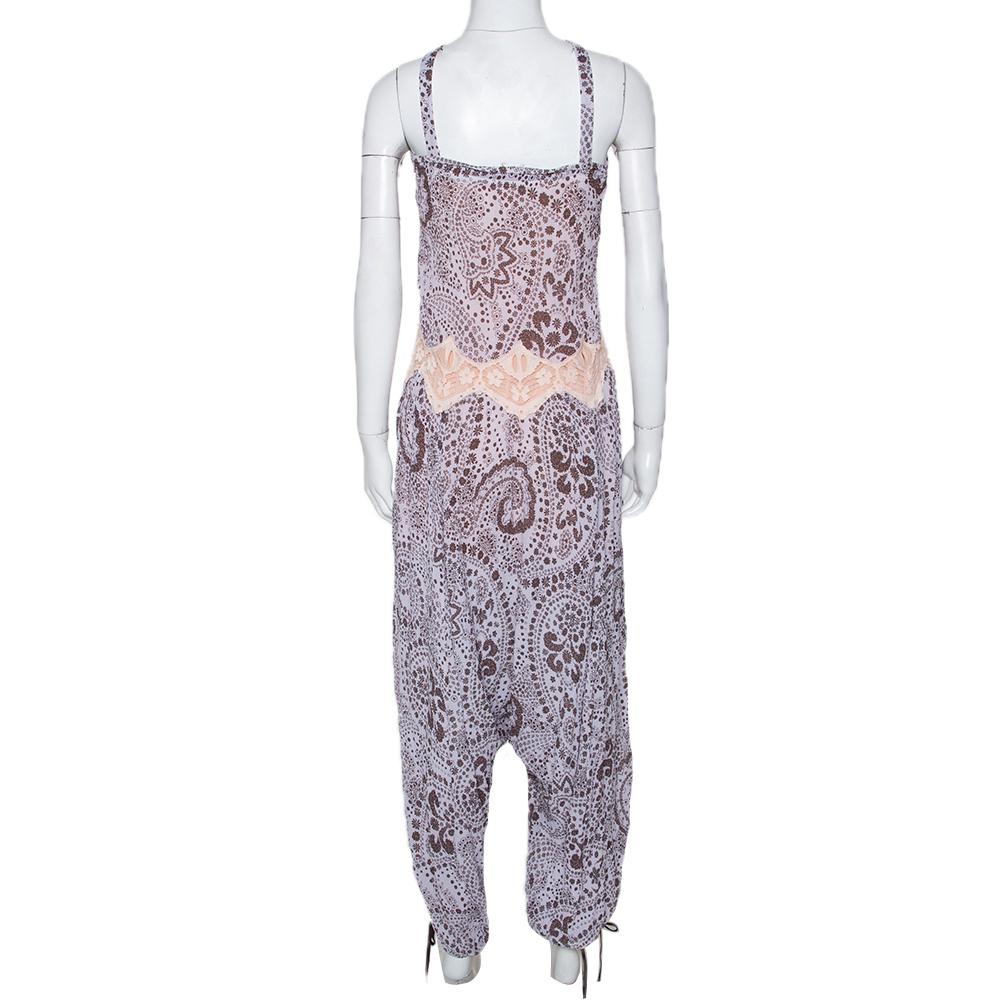 What's not to love about this jumpsuit from Chloe! In a mix of purple and brown shades, it flaunts a relaxed shape, slender straps and floral prints all over. A pair of flats will complement the jumpsuit beautifully.

Includes: Price Tag