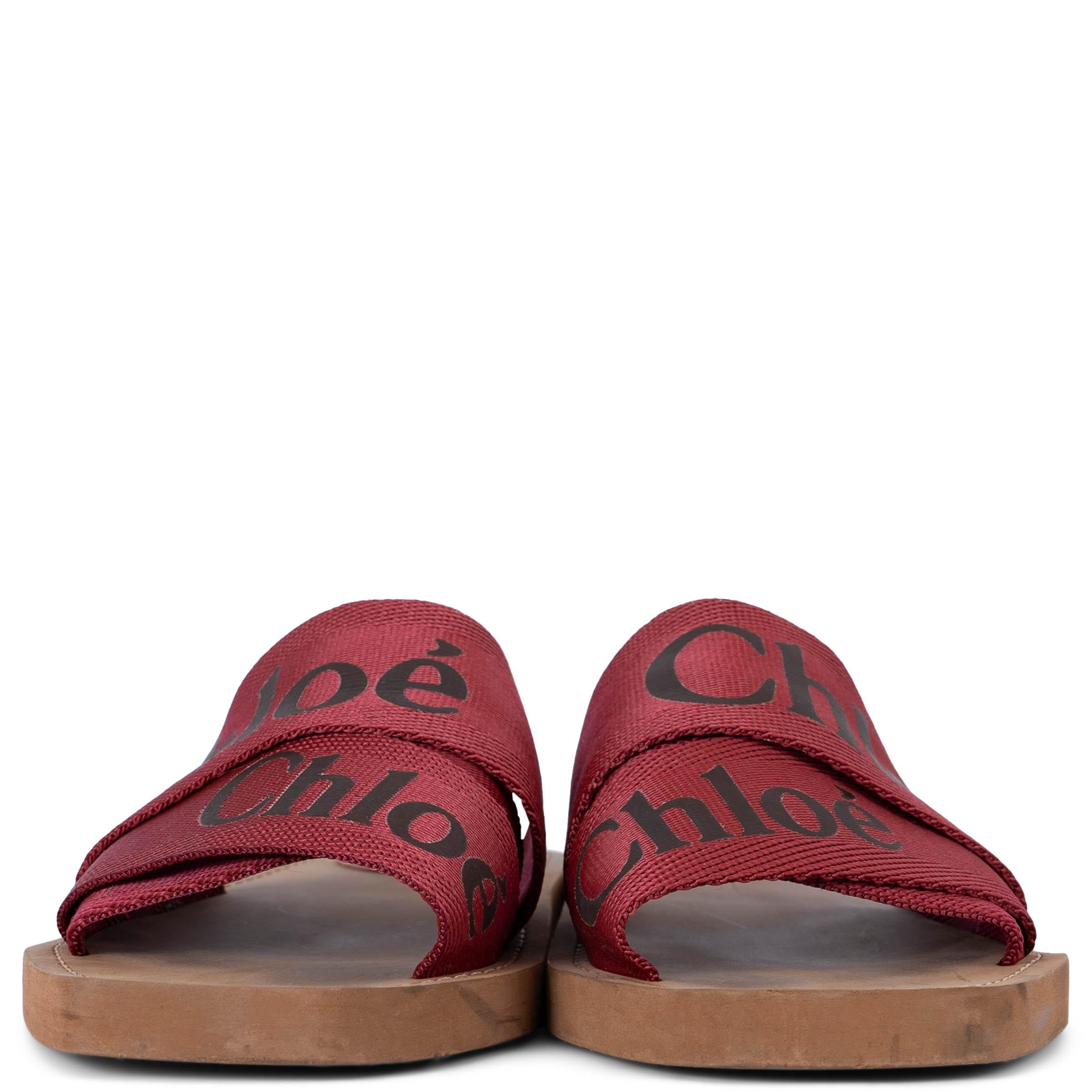 100% authentic Chloé Woody slide sandals in cherry red canvas webbing with black logo. Feature brown rubber soles and leather logo patch. Have been worn and are in excellent condition. 

2021

Measurements
Imprinted Size	35
Shoe Size	35
Inside