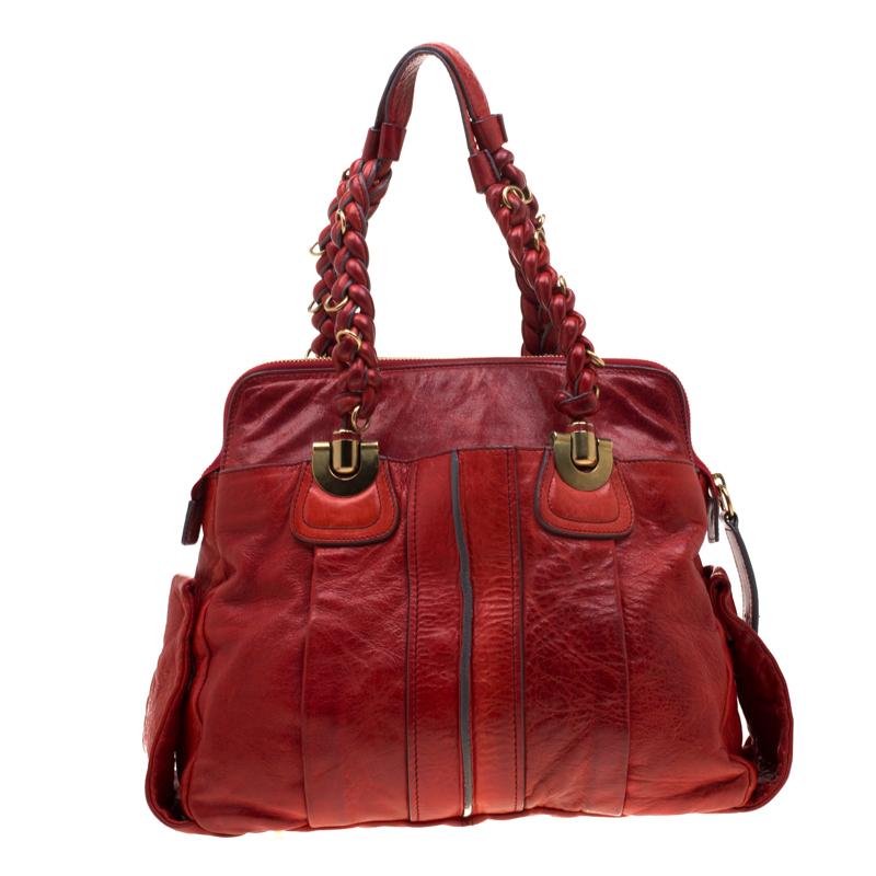 Get yourself this good-looking Heloise bag from Chloe for a posh look. The bag has been crafted from red leather and features dual braided handles. The zip closure opens to a fabric lined interior that will hold all your daily essentials. High on