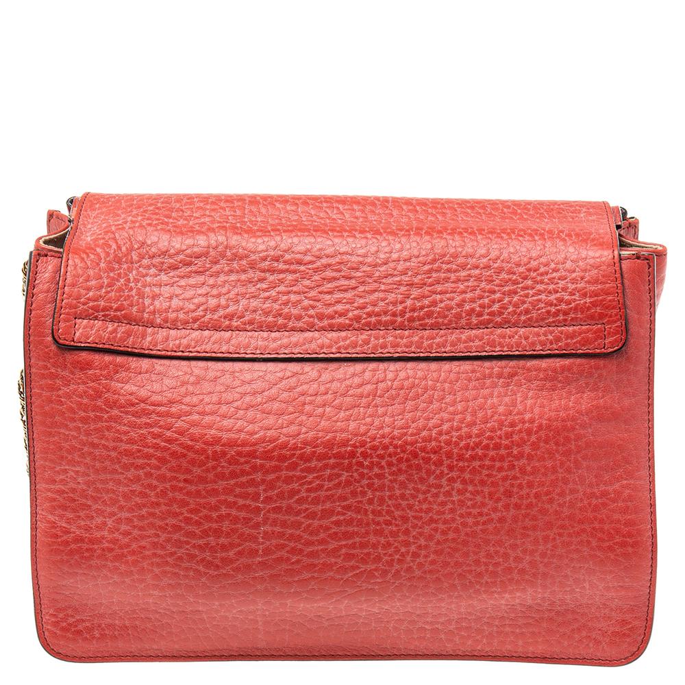Coming from the House of Chloe, this medium Sally shoulder bag is an absolutely chic accessory you need to own today! It is made from red leather, with a gold-toned logo decorating the flap. It has a fabric-lined interior and comes with a shoulder
