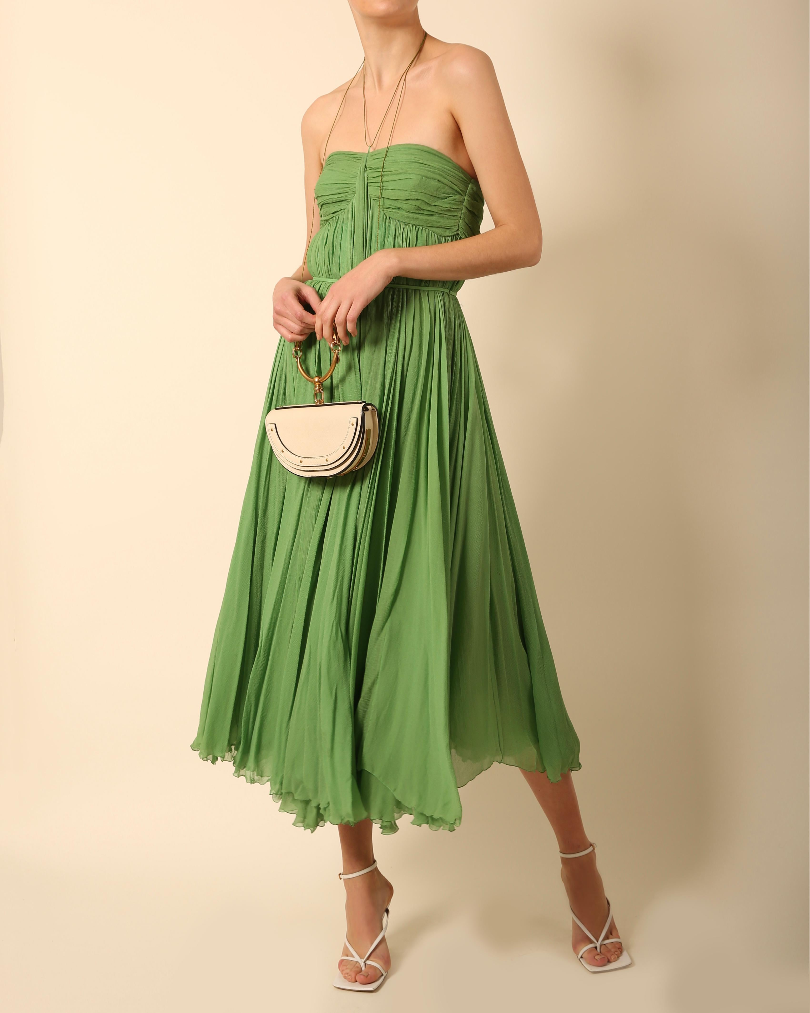Chloe Spring Summer 2004 strapless plisse green silk dress
Boning to the upper portion
Cinched in waist
Long rope ties with beaded ends wrap around the neck as seen on the runway
Concealed back zip

Composition:
100% Silk

Size:
Marked a FR 38,