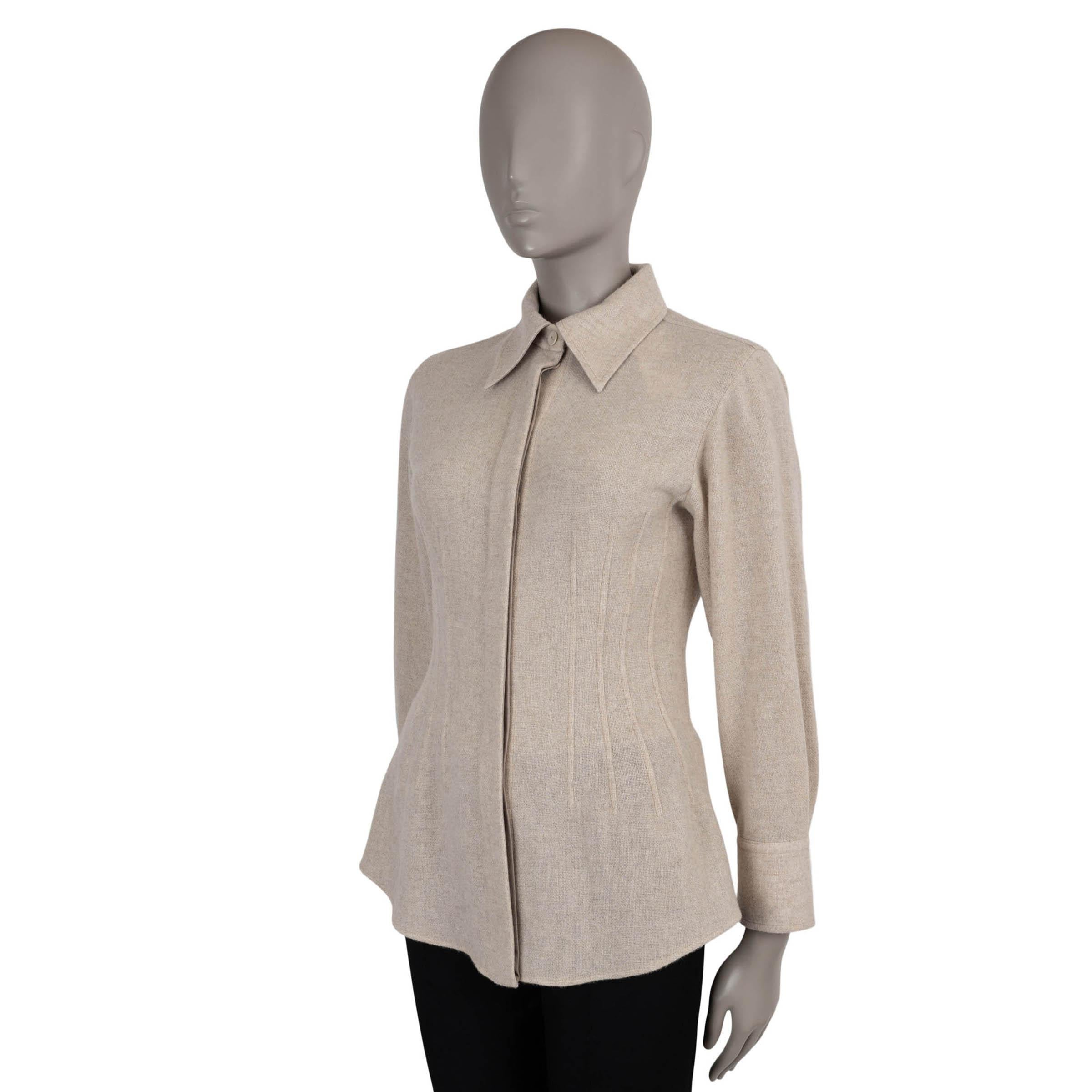 This 100% authentic Chloé button-up shirt is crafted in Sandy Khaki beige gauzy recycled wool (50%) and cashmere (50%). Designed with a relaxed fit, it features tonal textured piping that subtly contours an hourglass silhouette. A sharp point collar