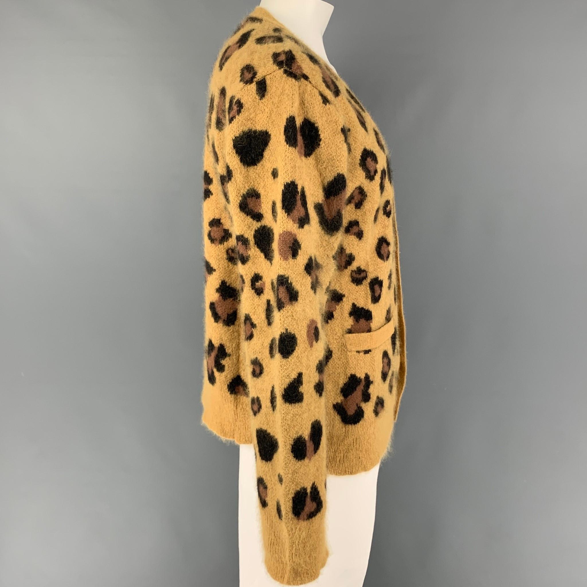 CHLOE SEVIGNY for OPENING CEREMONY cardigan comes in a mustard & dark brown animal print  angora blend featuring a oversized fit, front pockets, and a buttoned closure. 

Very Good Pre-Owned Condition.
Marked: M

Measurements:

Shoulder: 20