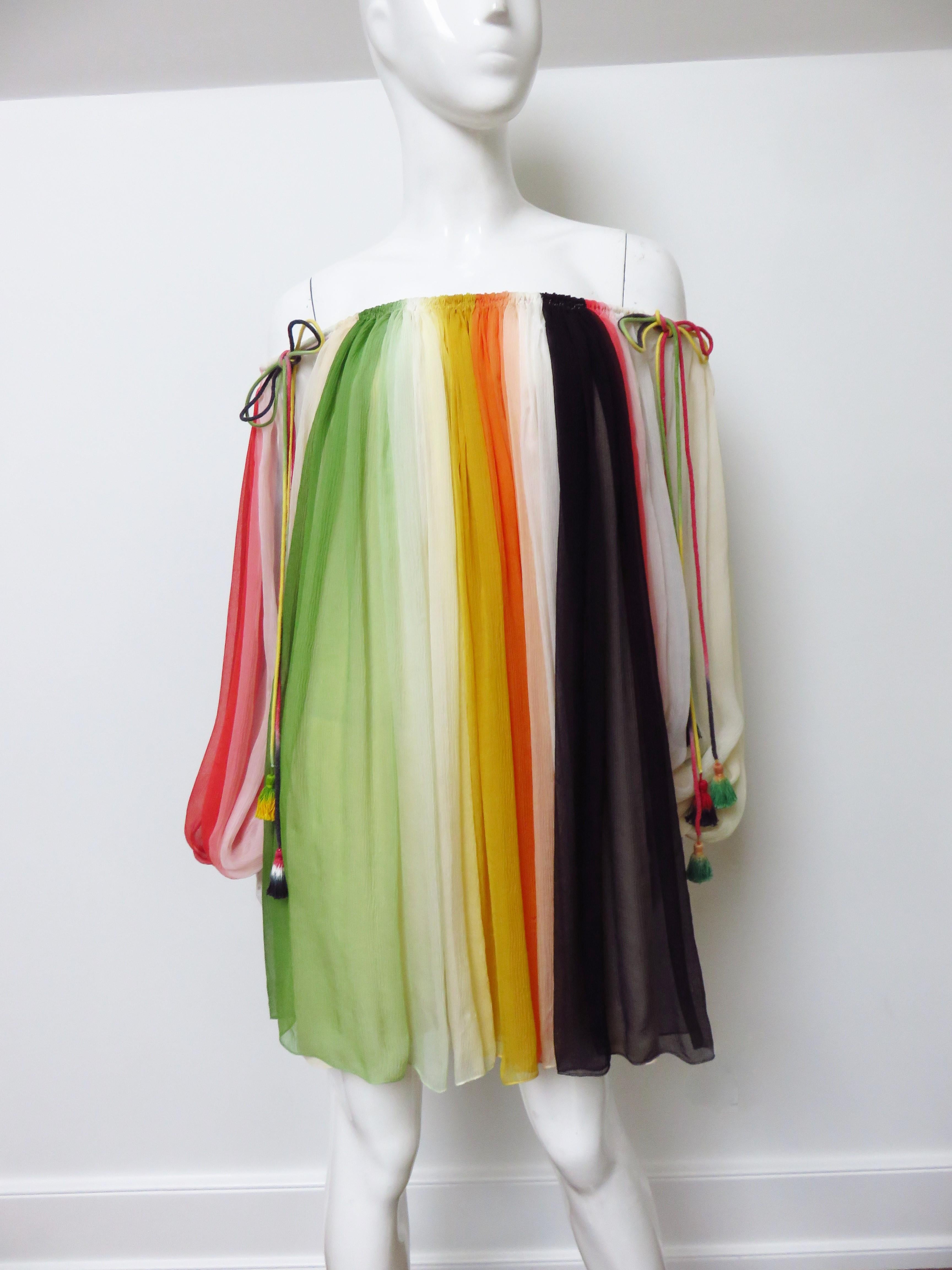 A gorgeous semi sheer silk dress in vertical lines of  rainbow colors melting into one another from Chloe. The body of the dress is full baby doll style with adjustable fine silk rope tasseled drawstrings around  the neckline so can be worn on or