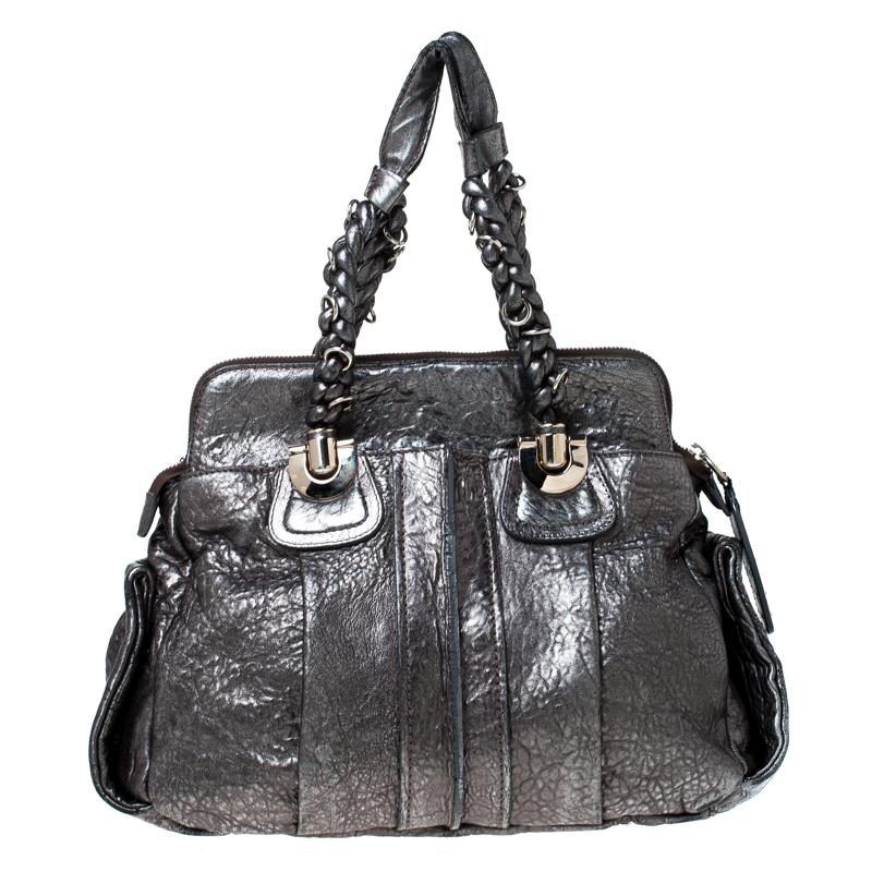 Chloe is known for quality craftsmanship in its designs and this satchel is a fine example. This elegant bag has been crafted from leather into a beautiful structure. The bag is equipped with a spacious fabric interior and two braided handles. Get