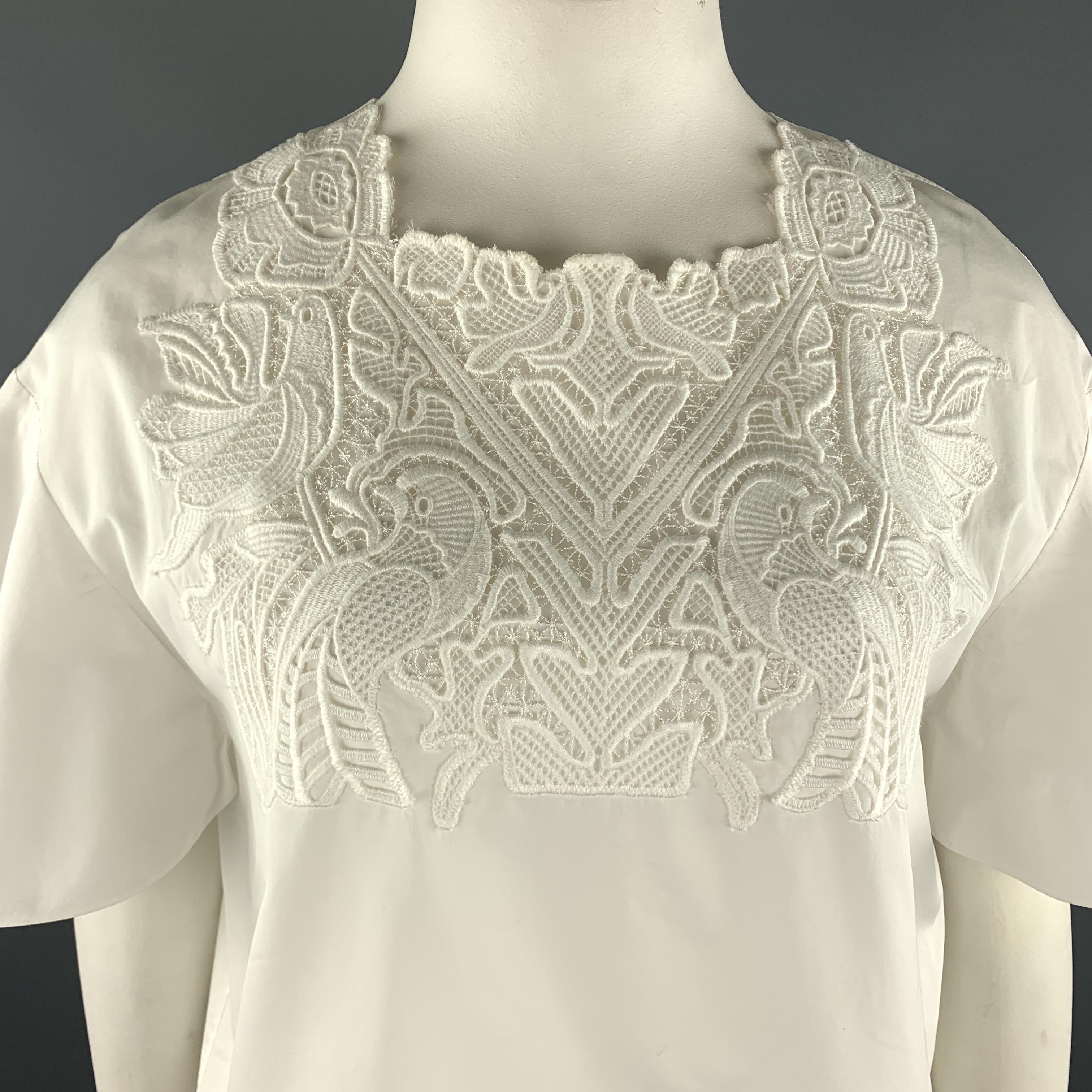 CHLOE top comes in white cotton poplin with a squared, lace embroidered collar, and short ruffled sleeves. Made in France.

Excellent Pre-Owned Condition.
Marked: FR 42

Measurements:

Shoulder: 22 in.
Bust: 44 in.
Sleeve: 8.5 in.
Length: 25 in.