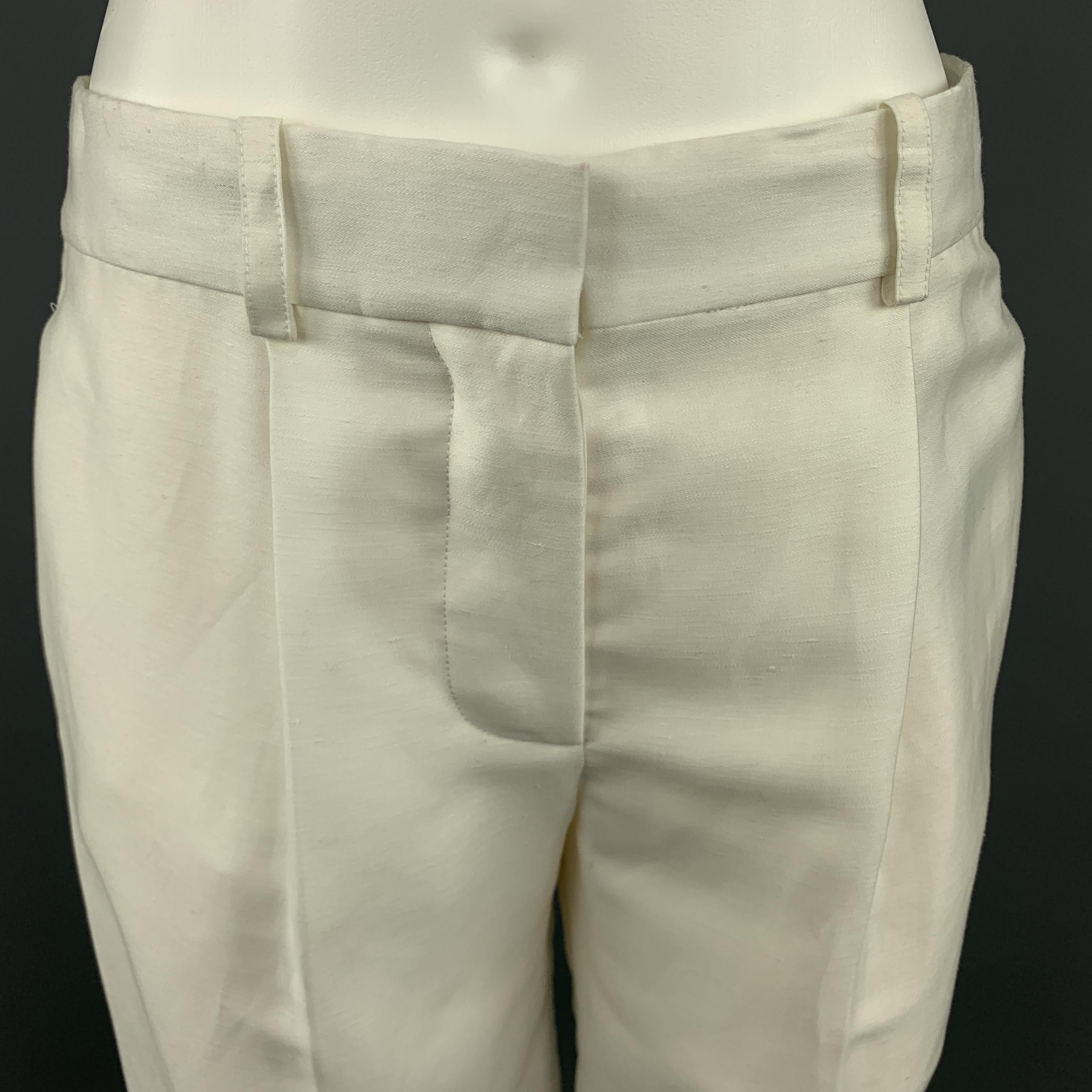 CHLOE Shorts comes in a cream tone in a solid silk material, with a pleated front, seam side pockets and a slit pocket at back. Made in France.
 
Excellent Pre-Owned Condition.
Marked: FR 34
 
Measurements:
 
Waist: 29 in.
Rise: 9.5 in.
Inseam: 11