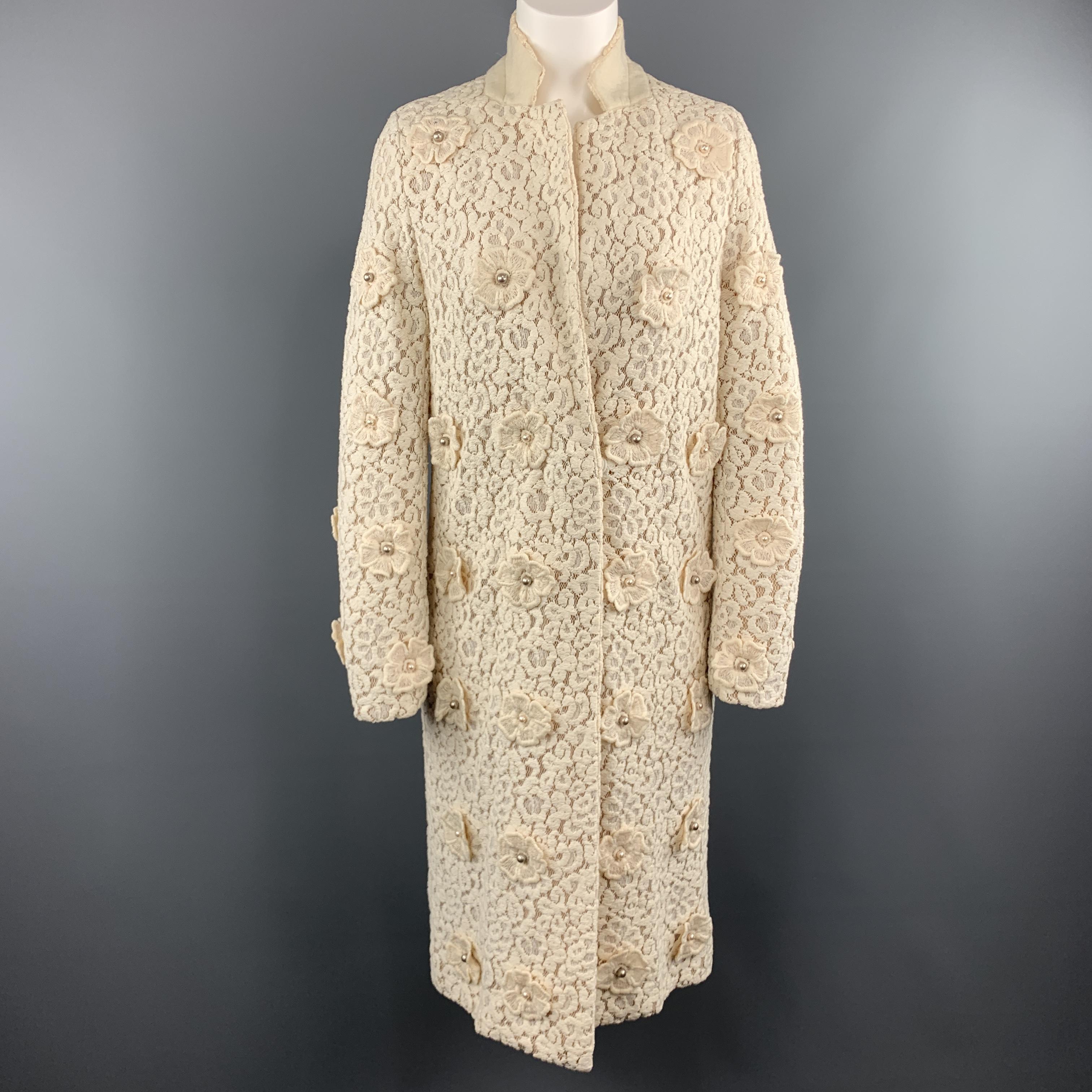 CHLOE evening coat comes in cream chunky lace with a notch lapel, hidden snap closures, tan silk chiffon liner, and flower applique's with faux pearls throughout. 

Excellent Pre-Owned Condition.
Marked: IT 40

Measurements:

Shoulder: 15 in.
Bust: