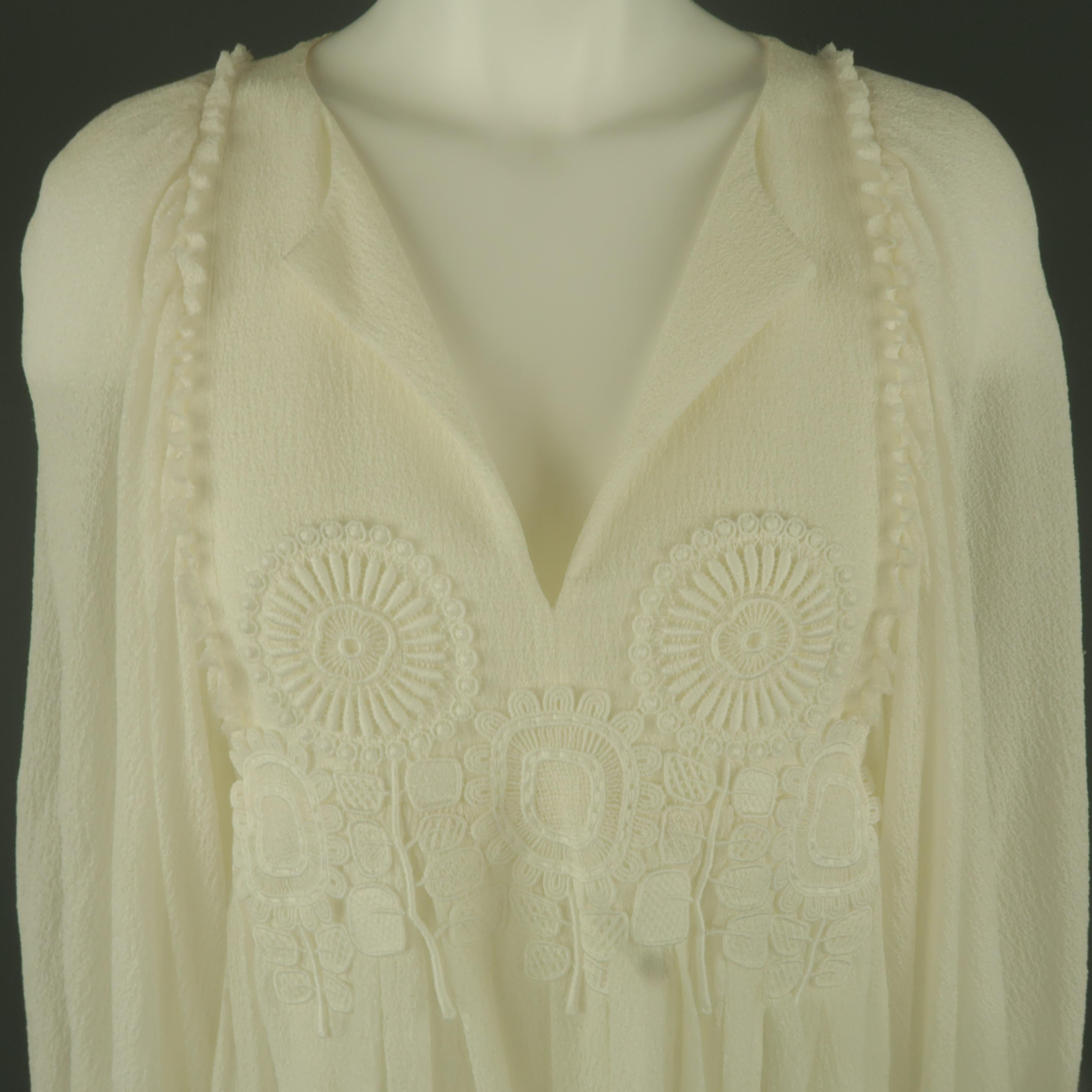 CHLOE tunic blouse comes in cream silk textured crepe with a slit neckline, embroidered appliques, ruffled trim, gathered A line silhouette, and balloon sleeves. Made in France.
 
Excellent Pre-Owned Condition. Retails: $1,600.00.
Marked: FR 40
