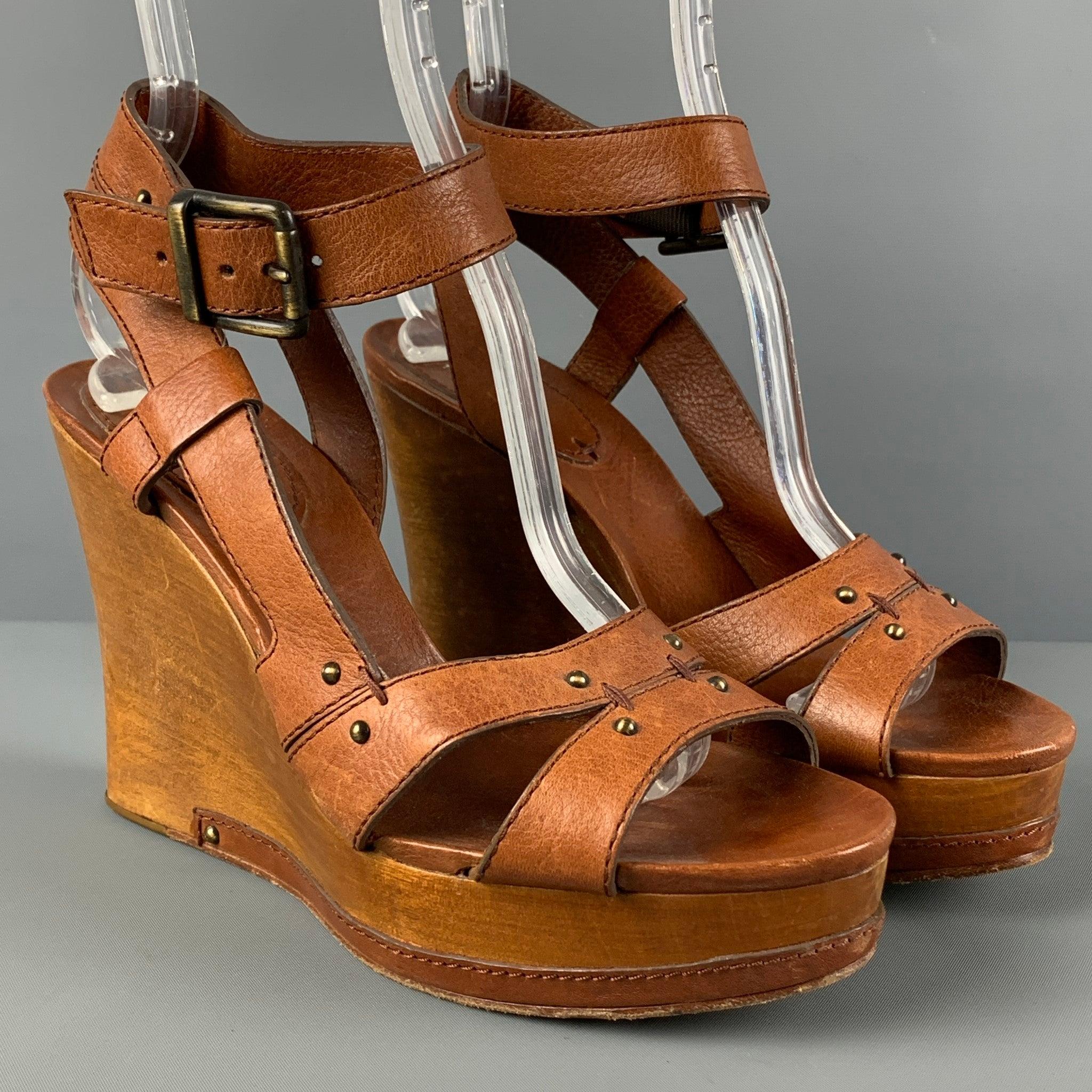 CHLOE sandals comes in a tan leather featuring a platform style, open toe, strap closure, and a wedge heel. Made in Italy.
 Good
 Pre-Owned Condition. Moderate wear. As-is.  
 

 Marked:  39 
 

 Measurements: 
  Heel: 4.25 inches Platform: 1.25