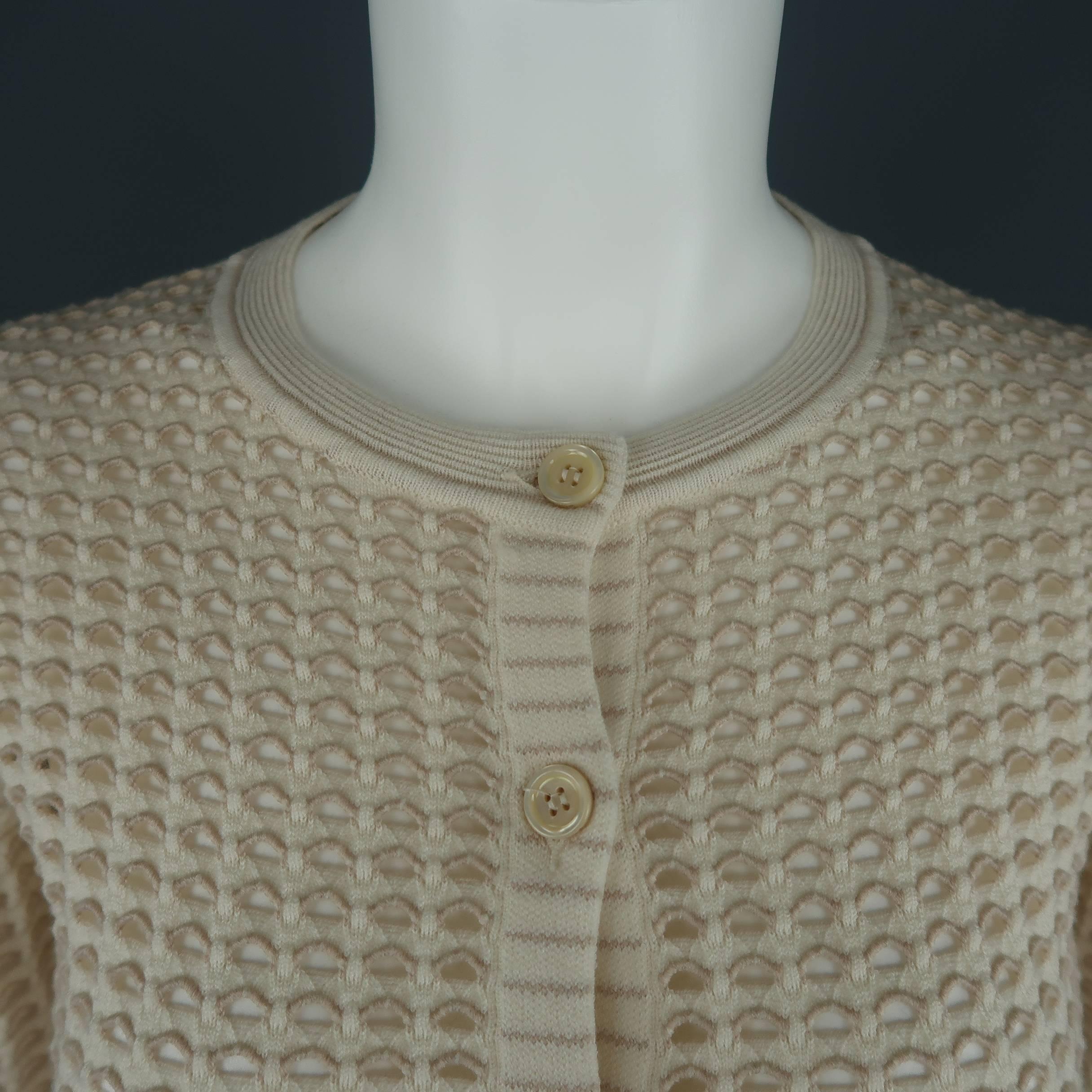 CHLOE cardigan comes in a cream stretch wool mesh knit with taupe accents featuring a crewneck and button up front. Made in Italy.
 
Excellent Pre-Owned Condition.
Marked: L
 
Measurements:
 
Shoulder: 13 in.
Bust: 32 in.
Sleeve: 24 in.
Length: 21