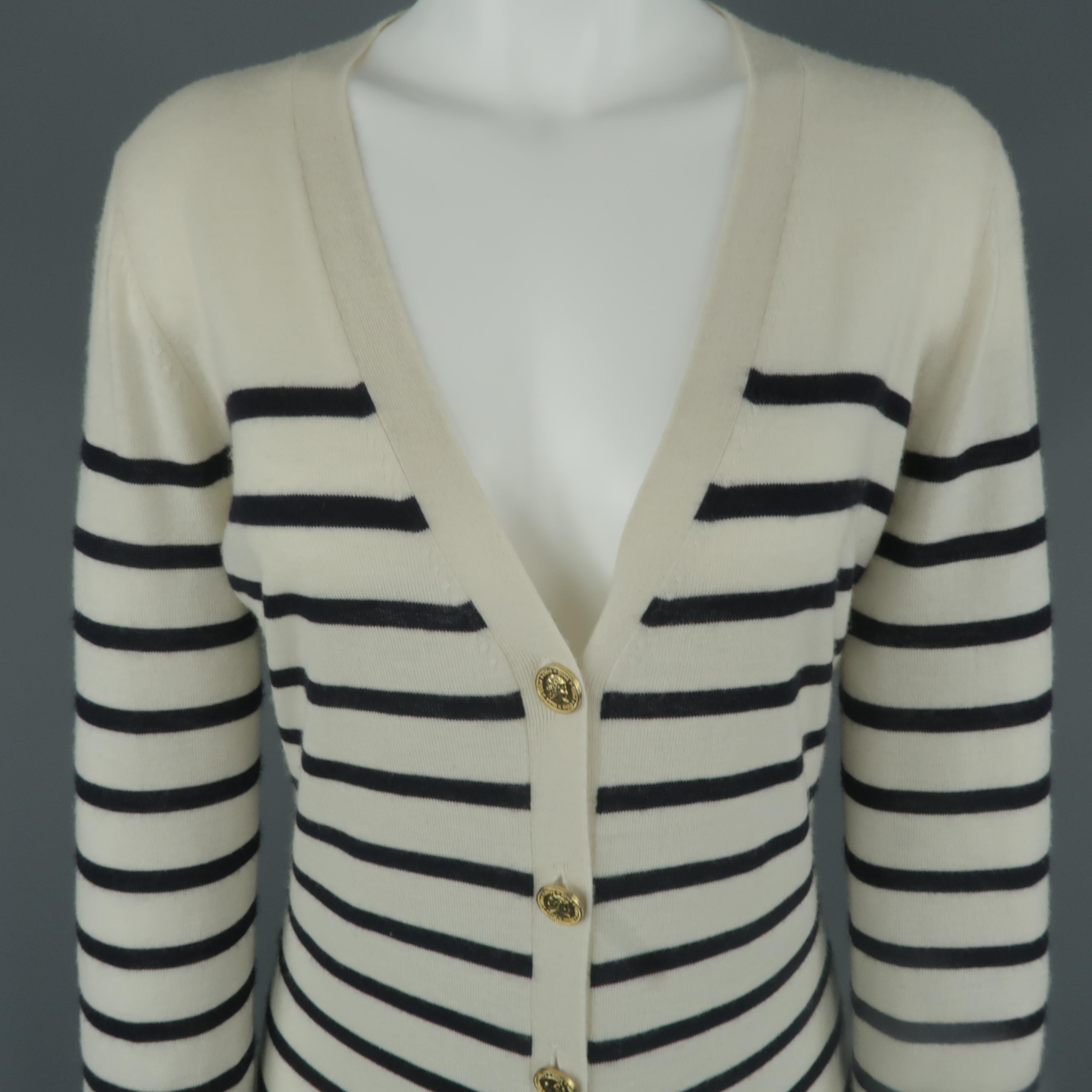 CHLOE cardigan comes in cream and navy sailor striped cashmere with a deep V neck, patch pockets, extended hemline, and gold tone metal coin buttons.
 
Excellent Pre-Owned Condition.
Marked: M
 
Measurements:
 
Shoulder: 16 in.
Bust: 38 in.
Sleeve: