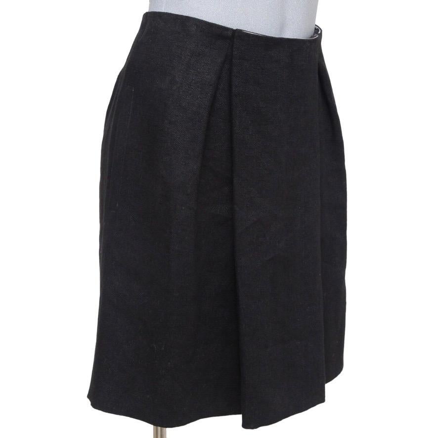GUARANTEED AUTHENTIC CHLOE BLACK COTTON SILK BLEND PLEATED SKIRT

Design:
- Front large inverted pleated flap.
- Side pockets.
- Rear zipper and dual hook-n-eye closure.
- Fully lined.

Size: 36

Measurements (Approximate):
- Waist: 14.75