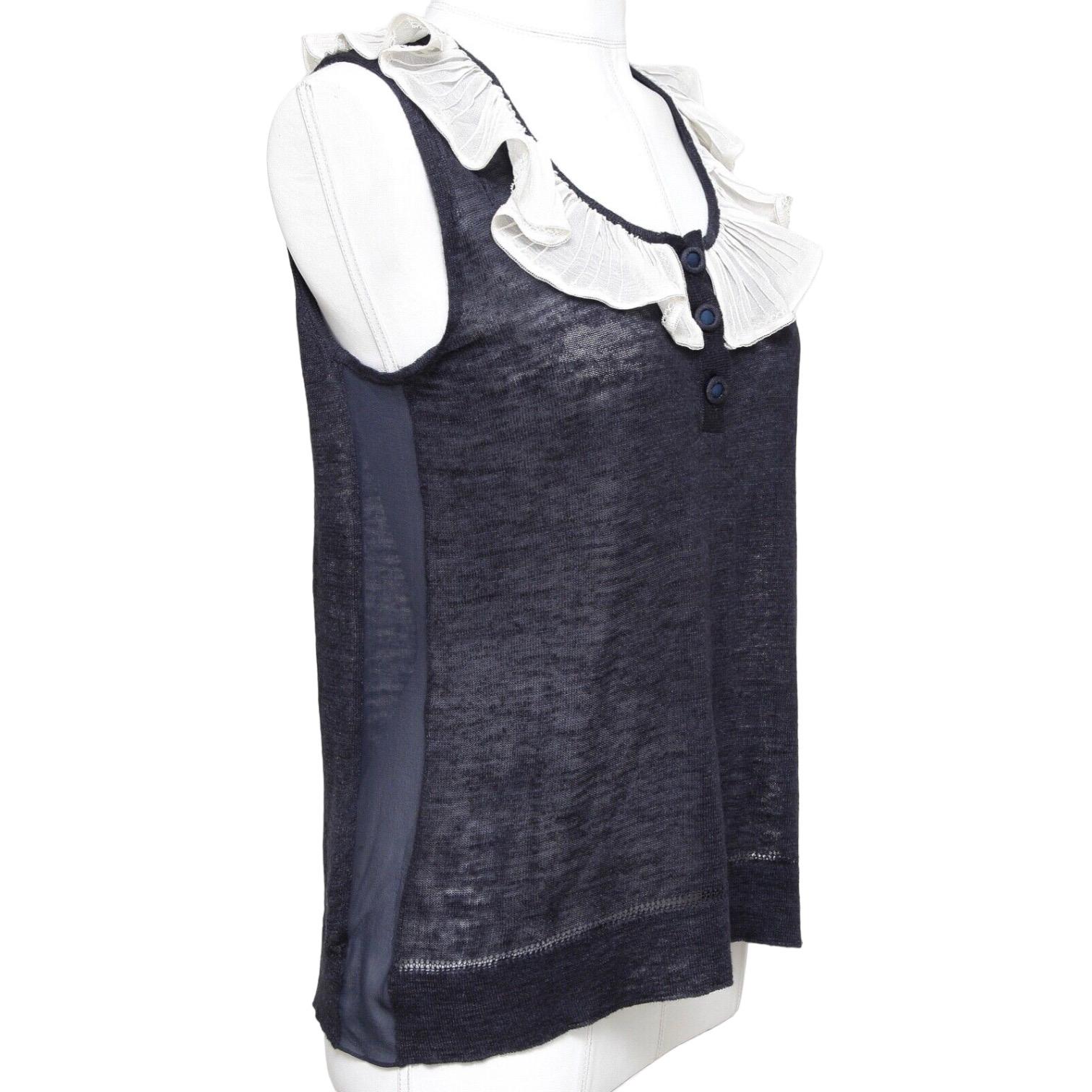 GUARANTEED AUTHENTIC CHLOE 2007 SLEEVELESS LIGHTWEIGHT NAVY TOP

Design:
- Lightweight sleeveless navy silk blend top with ivory ruffle around neckline.
- 3 button henley style slip on.
- Side sheer silk panels.

Size: XS

Material: 70% Linen, 30%