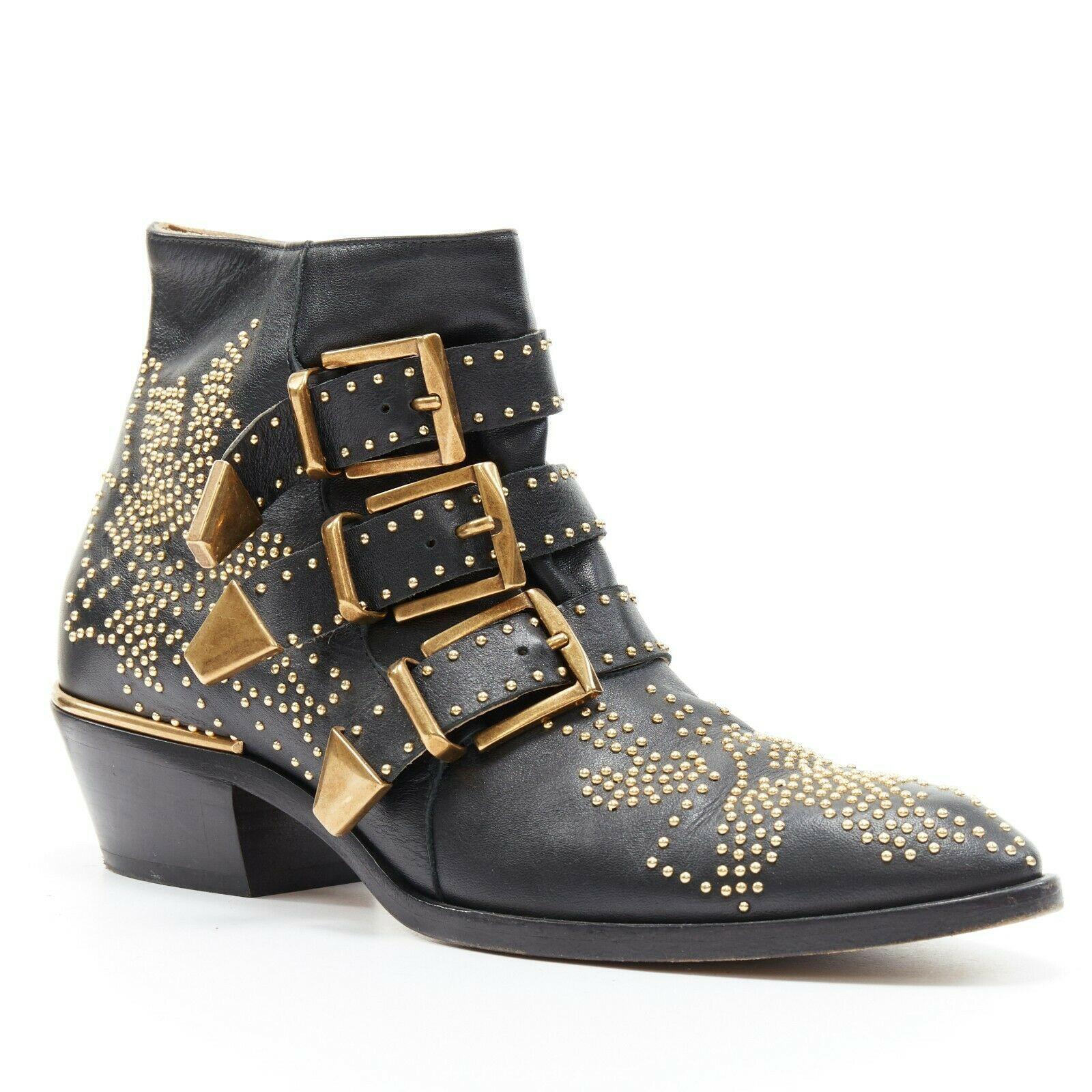 CHLOE Susanna black leather gold floral micro stud trio buckle ankle boot EU35
CHLOE
Signature Susanna boot. 
Black leather upper. 
Gold-tone microstud embellishment. 
Floral stud design. 
Triple angular hardware decorative boot strap. 
Metal bar