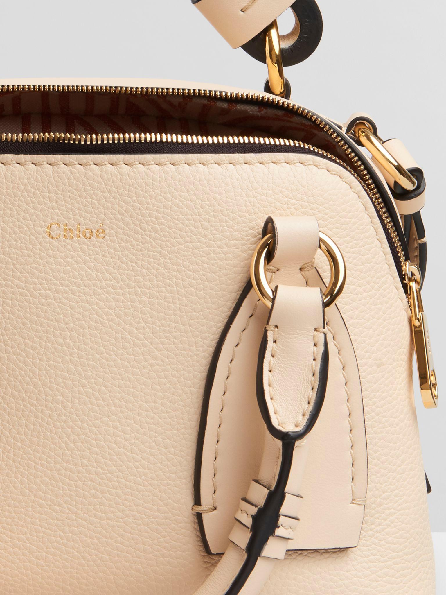 Chloe Sweet Beige Grained & Shiny Calfskin Daria Medium Handbag

- Large zip puller
- Worn on the body, across the body or by hand
- 2 main zipped compartments
- 2 flat inside zipped pockets
- Protective bottom studs
- ChloÃ© cotton jacquard